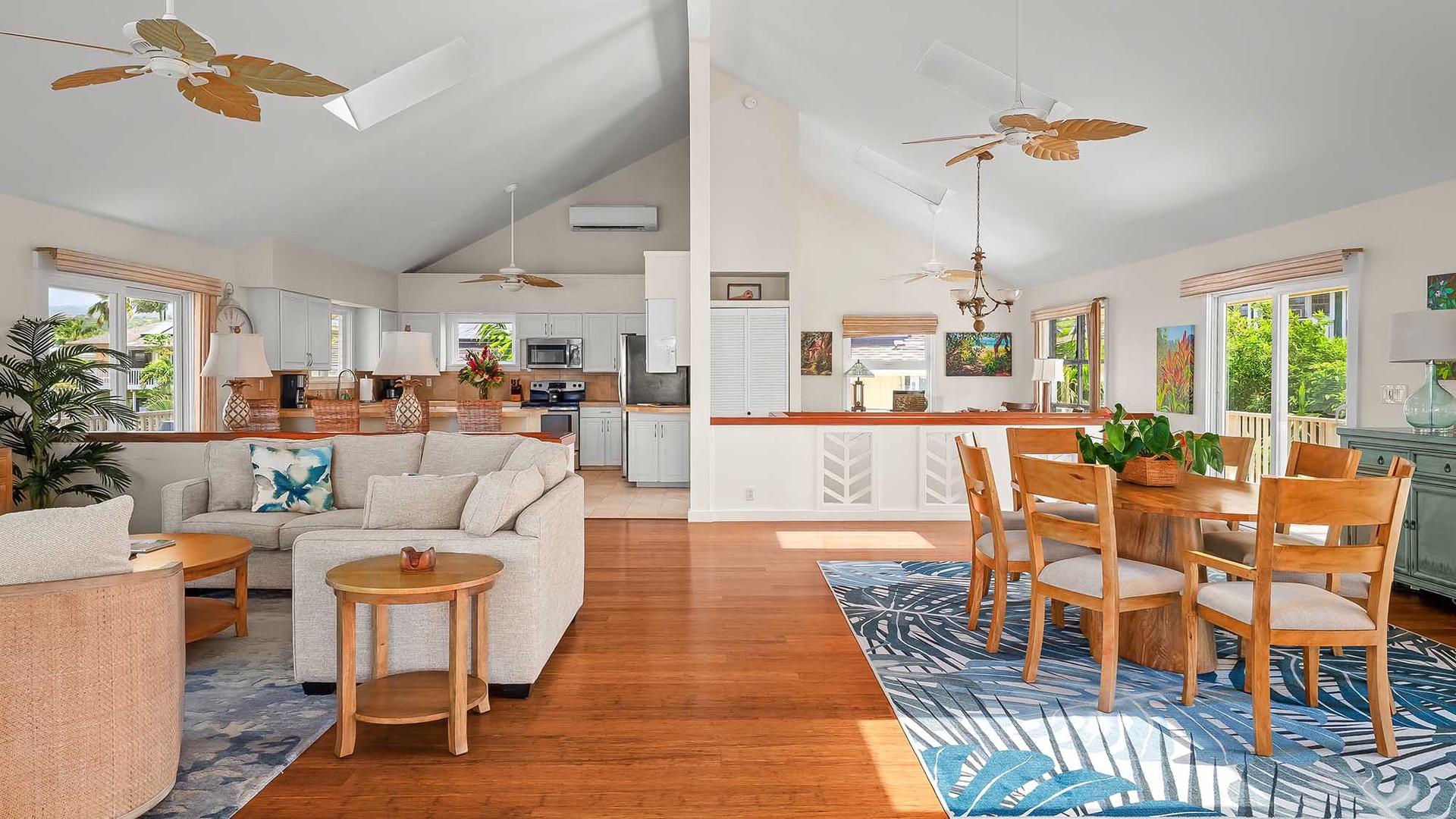 Relax in your spacious open-concept retreat where living, dining, and kitchen flow seamlessly together. Tropical breezes drift through as you unwind on the comfy sectional or gather around the dining table, surrounded by warm wood accents and island-inspi