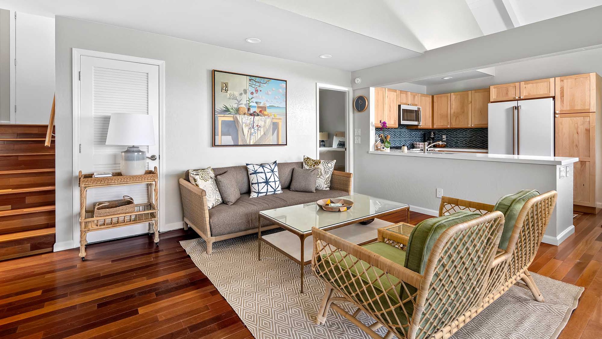 Settle into your bright, open living space where rich wood floors and coastal charm invite you to unwind. Your full kitchen awaits your favorite recipes, and the cozy seating area is perfect for morning coffee or evening conversation.