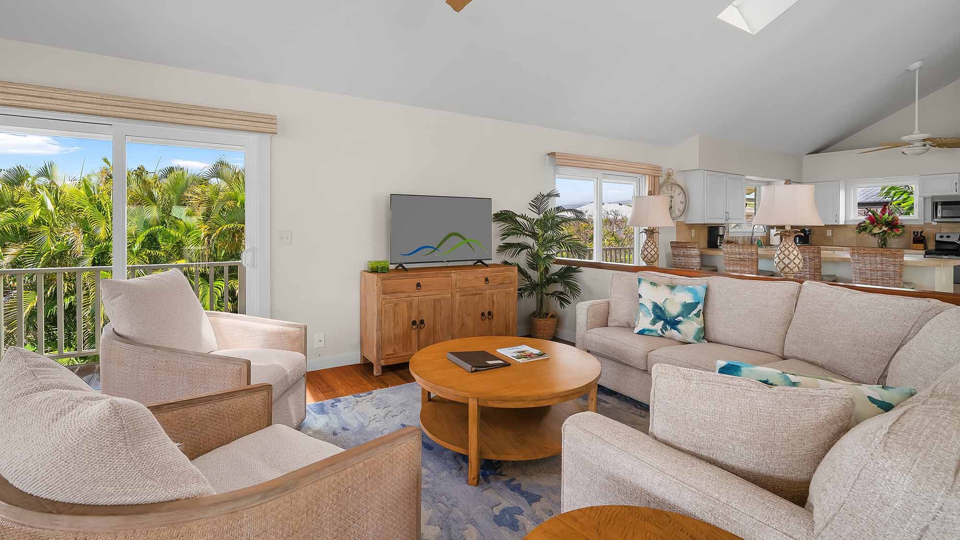 Settle into your coastal living room, where tropical palms sway outside your windows and plush seating invites you to unwind with views of lush greenery all around.