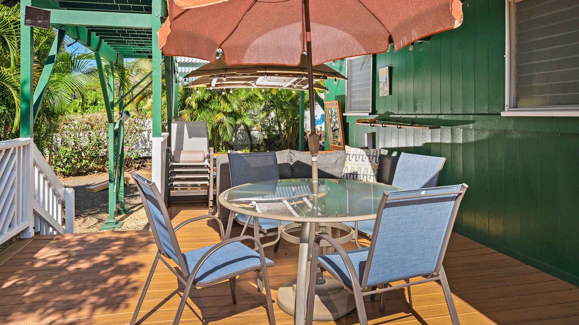 Step onto your private deck where tropical breezes meet comfort—dine under the umbrella or lounge in the cozy seating area.