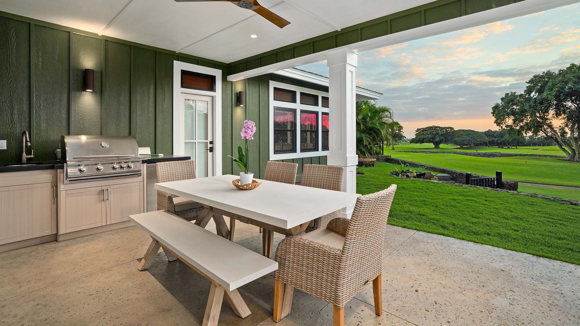 Your covered outdoor kitchen opens to rolling golf course views, where you'll grill and dine surrounded by tropical paradise.