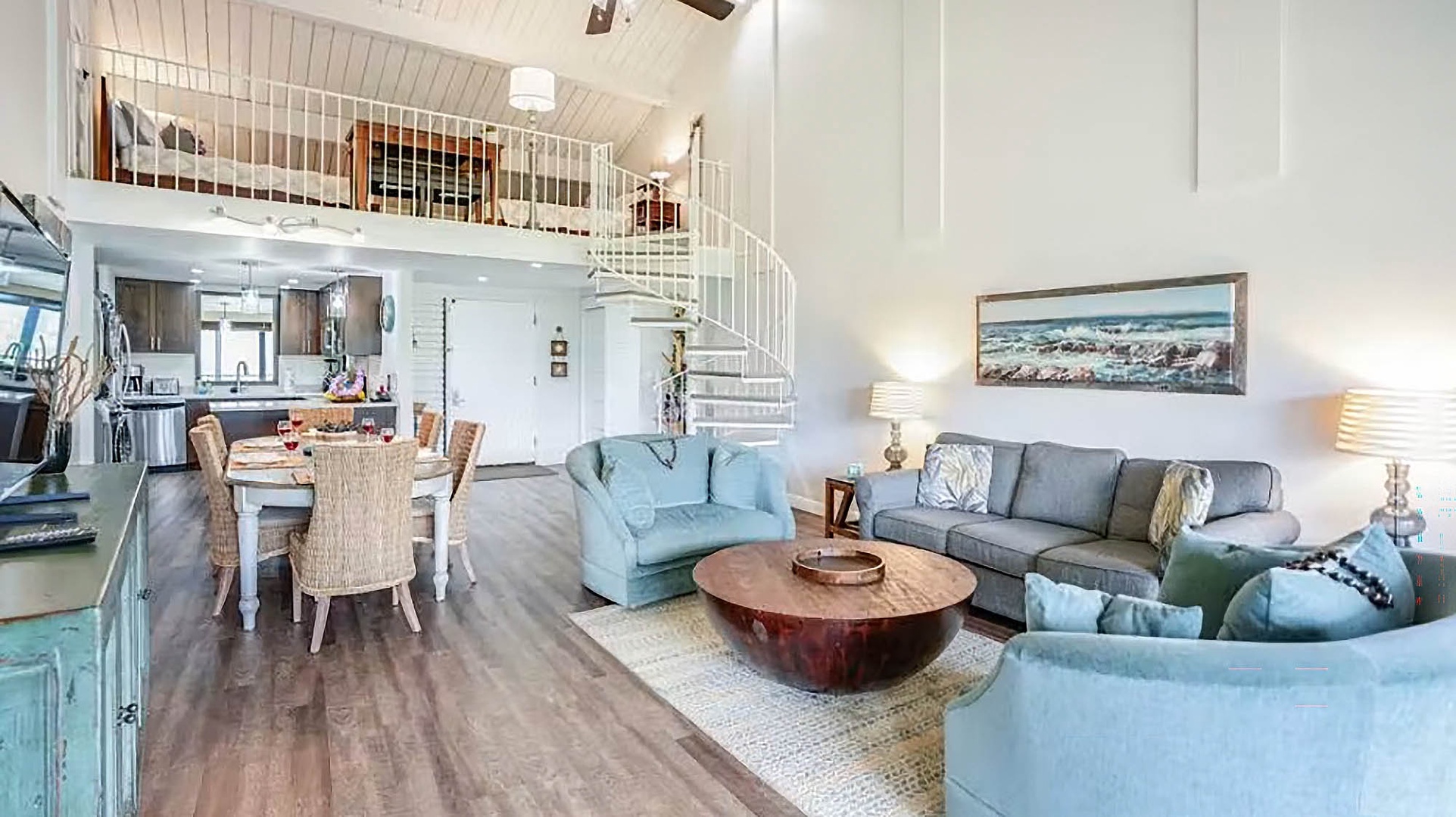 Step into your airy, light-filled retreat with soaring ceilings and coastal charm. Curl up in the comfortable living area, gather around the dining table, or explore the loft above—all within your spacious home away from home.