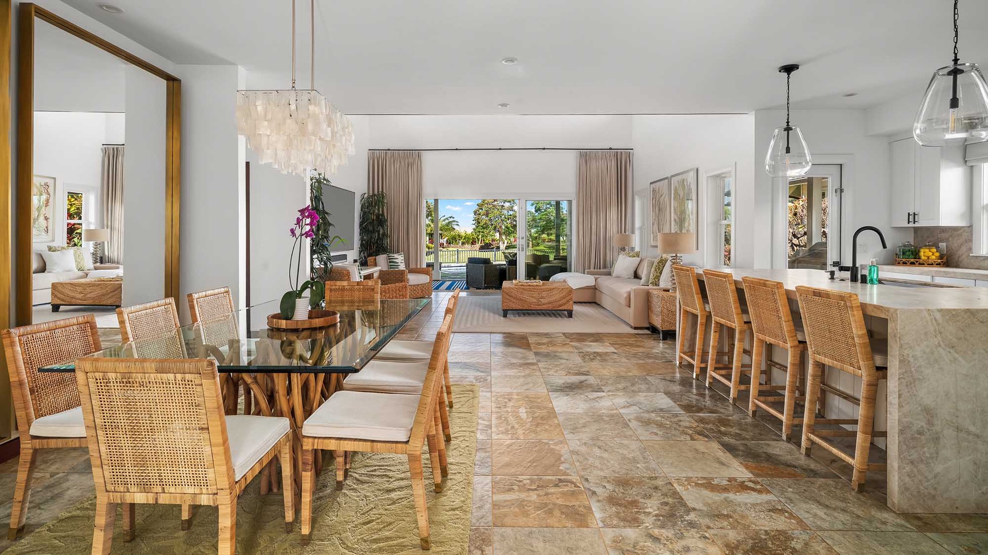 Your bright, open-concept living space flows seamlessly from kitchen to dining to lounge, framed by sleek fixtures and natural light pouring through expansive windows overlooking lush greenery.
