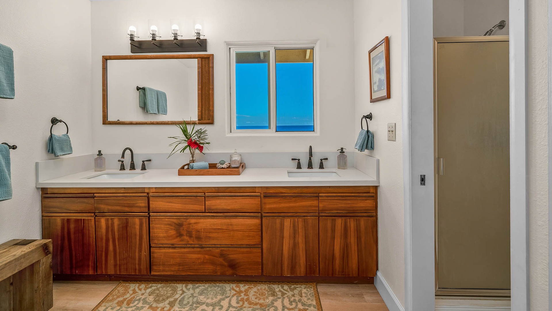 Step into your spacious bathroom with dual vanities and rich wood cabinetry. Fresh towels and thoughtful details make it easy to settle in and unwind.