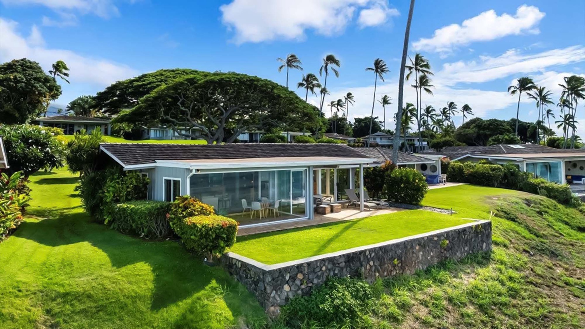 Modern tropical retreat nestled among swaying palms and lush gardens in this stunning Hawaiian setting.