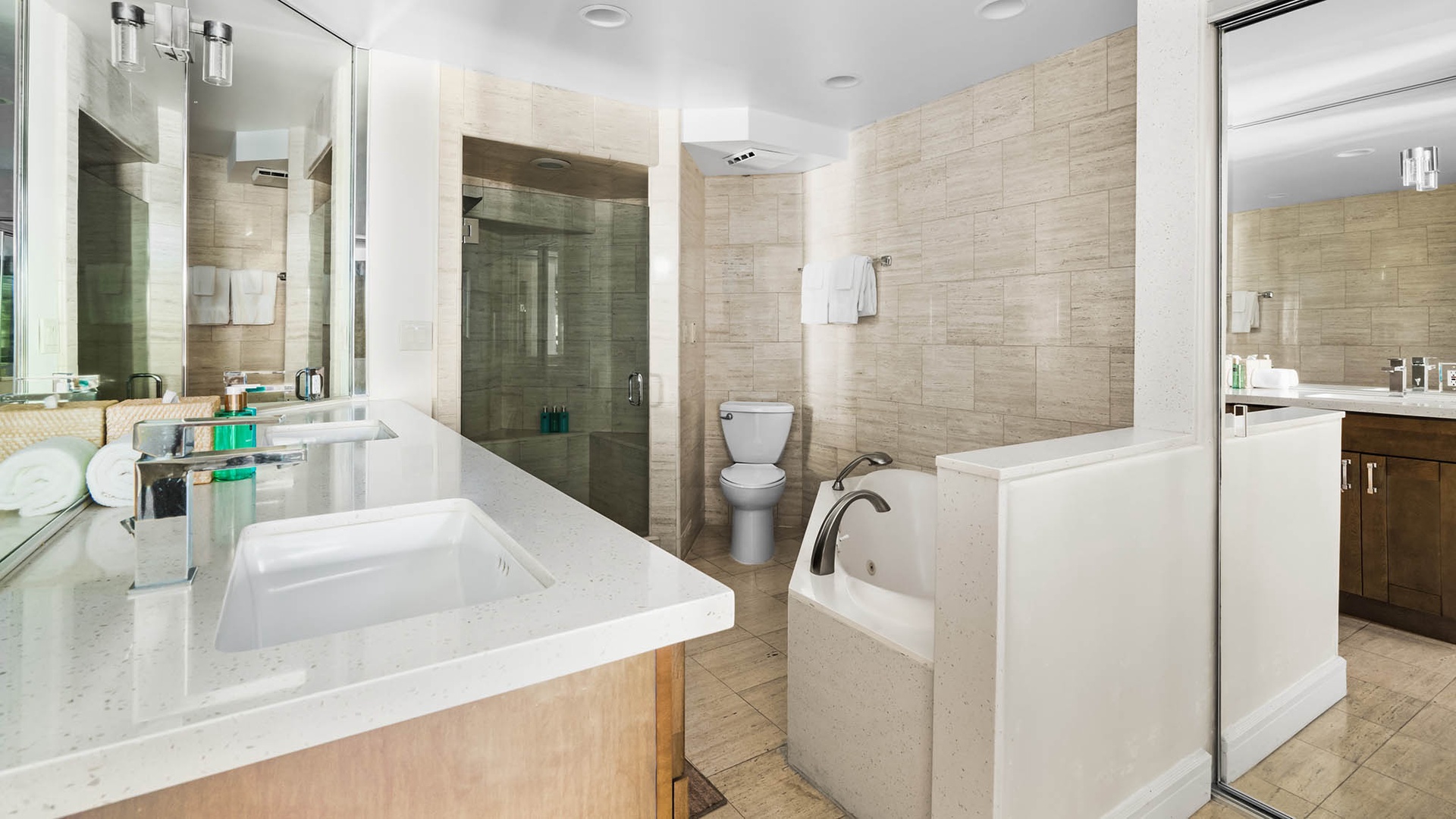 Unwind in your spa-like bathroom with a soaking tub, walk-in shower, dual vanities, and warm wood-tone tile that invites ultimate relaxation.