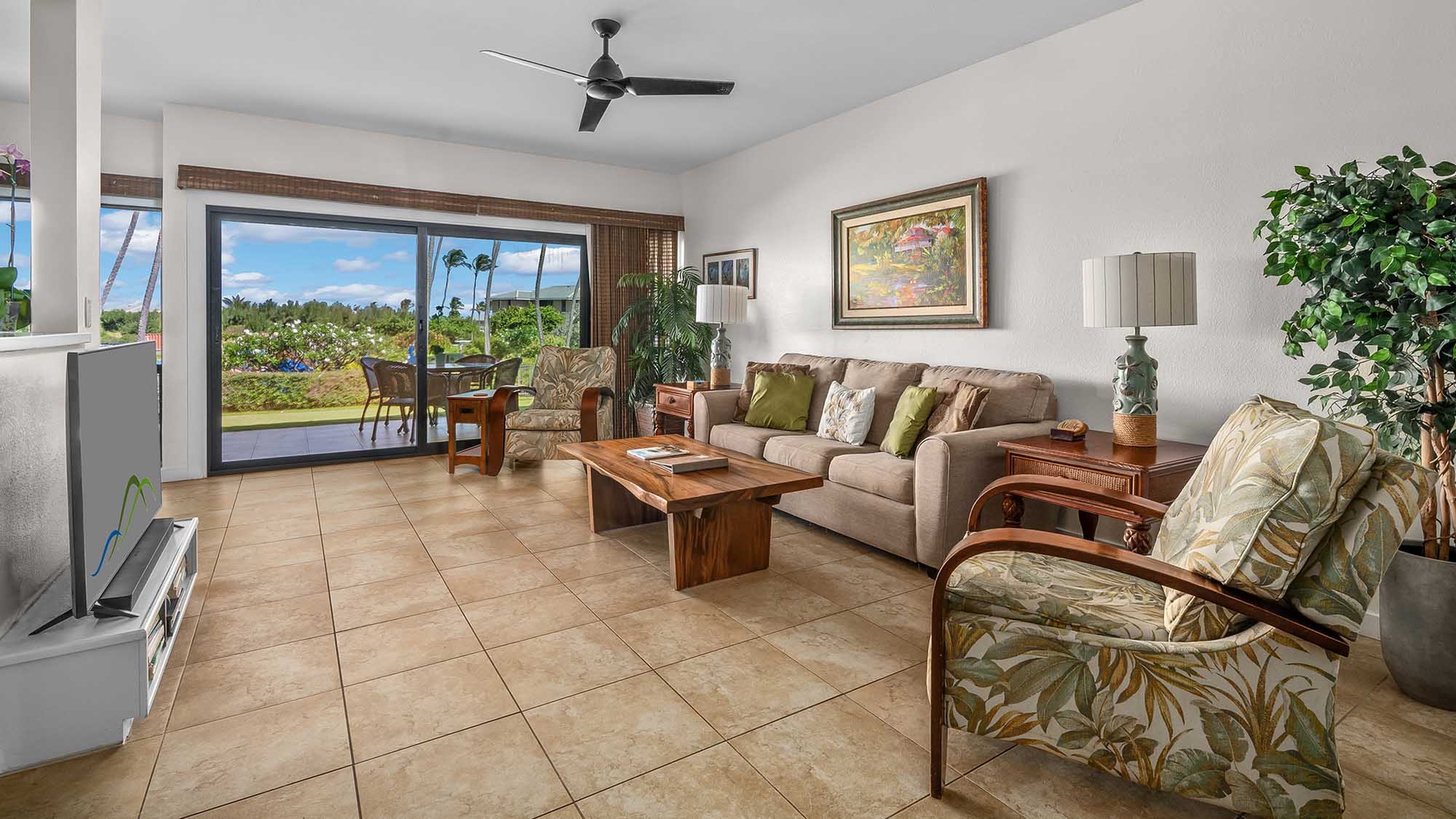 Unwind in your spacious living room with tropical breezes, island-inspired décor, and sliding doors opening to lush garden views perfect for morning coffee or sunset relaxation.