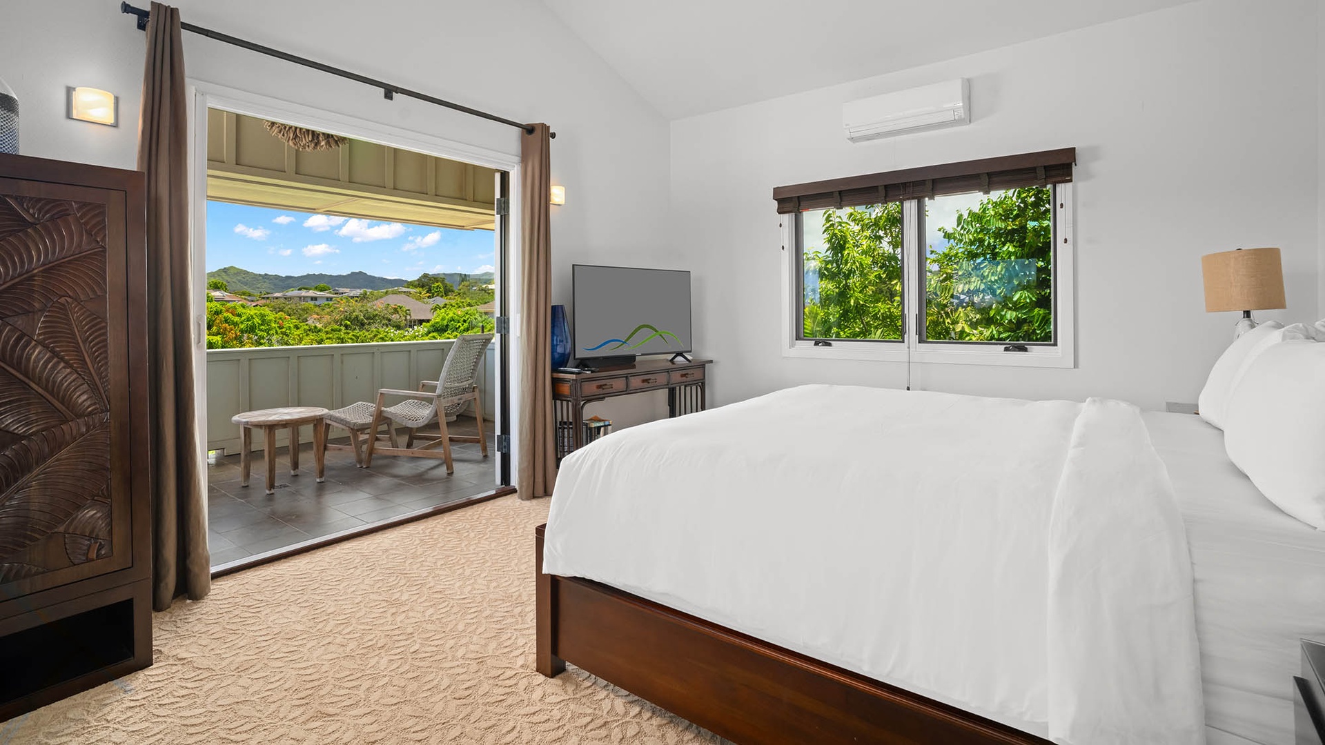 Wake up to mountain and garden views from your bright bedroom, where crisp linens and a private balcony with seating await your peaceful mornings.