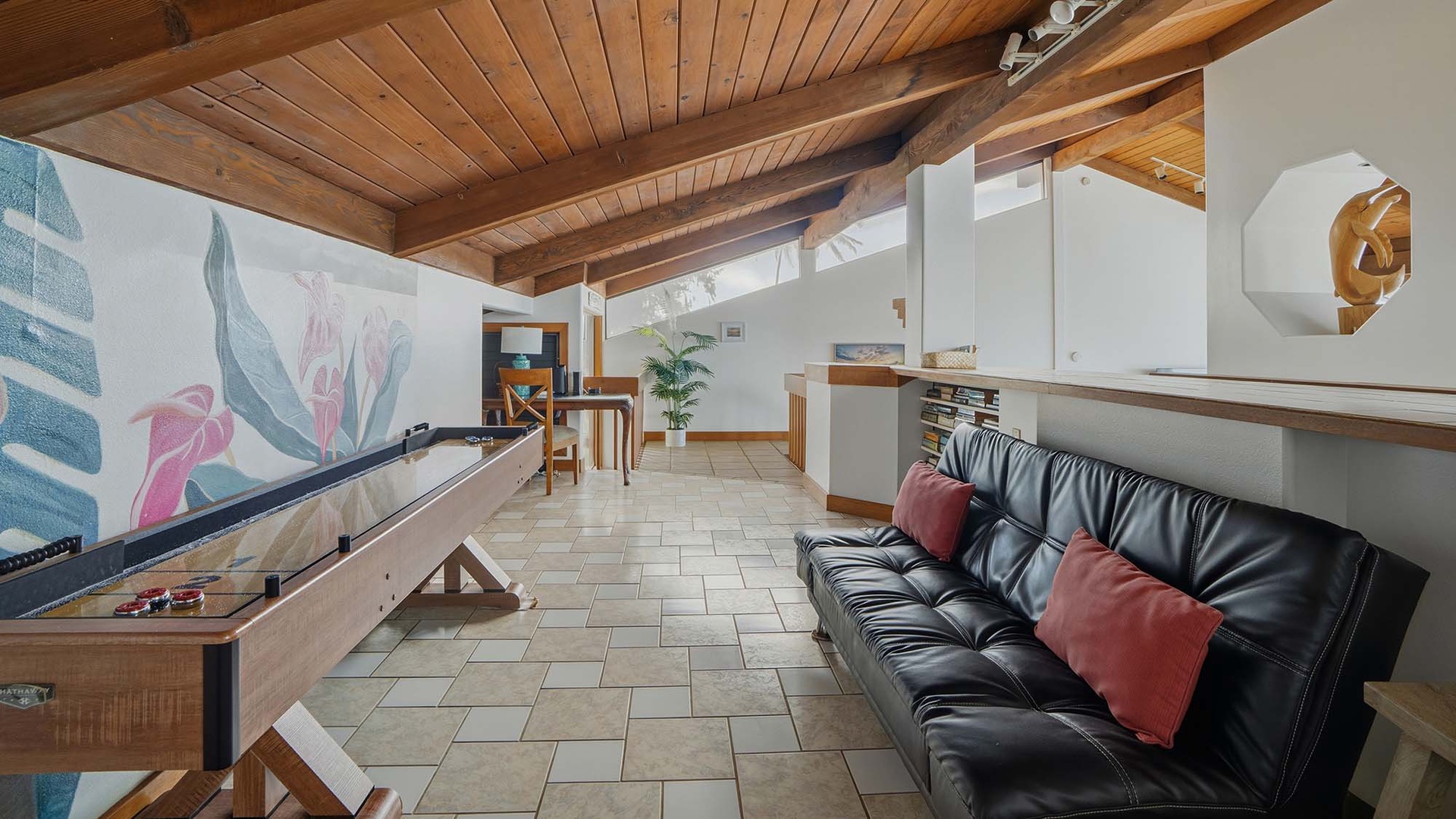 Unwind in this bright loft space with exposed wooden beams, comfortable leather seating, and creative touches that make you feel right at home.