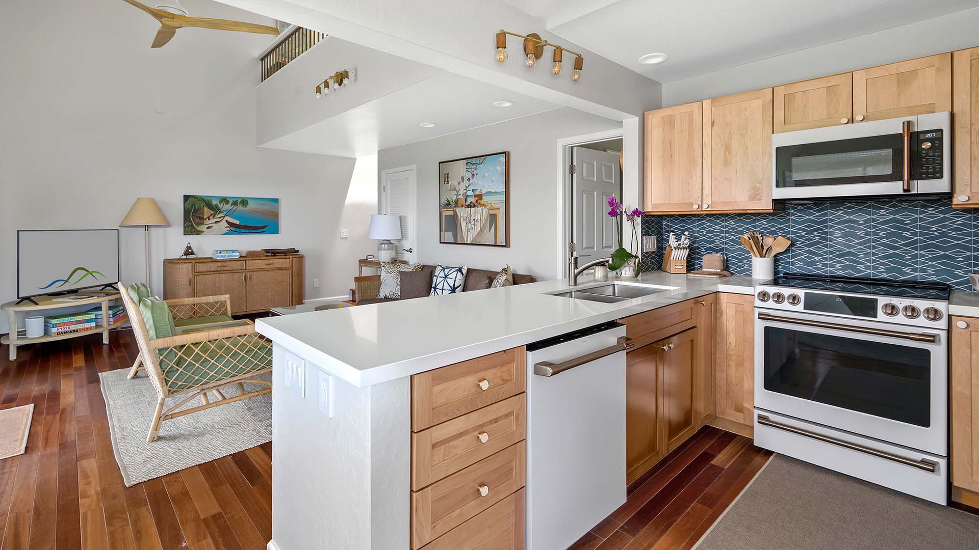 Step into your bright, coastal retreat where natural wood tones and breezy accents create a welcoming haven. The open kitchen flows seamlessly into the living space, perfect for gathering after a day at the beach.