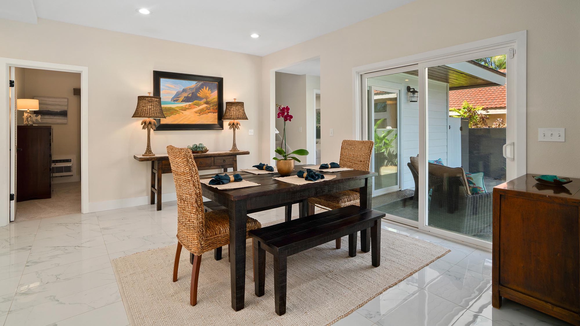 Gather around the inviting dining table for meals and conversations, with easy access through the open glass doors to your private outdoor patio retreat.
