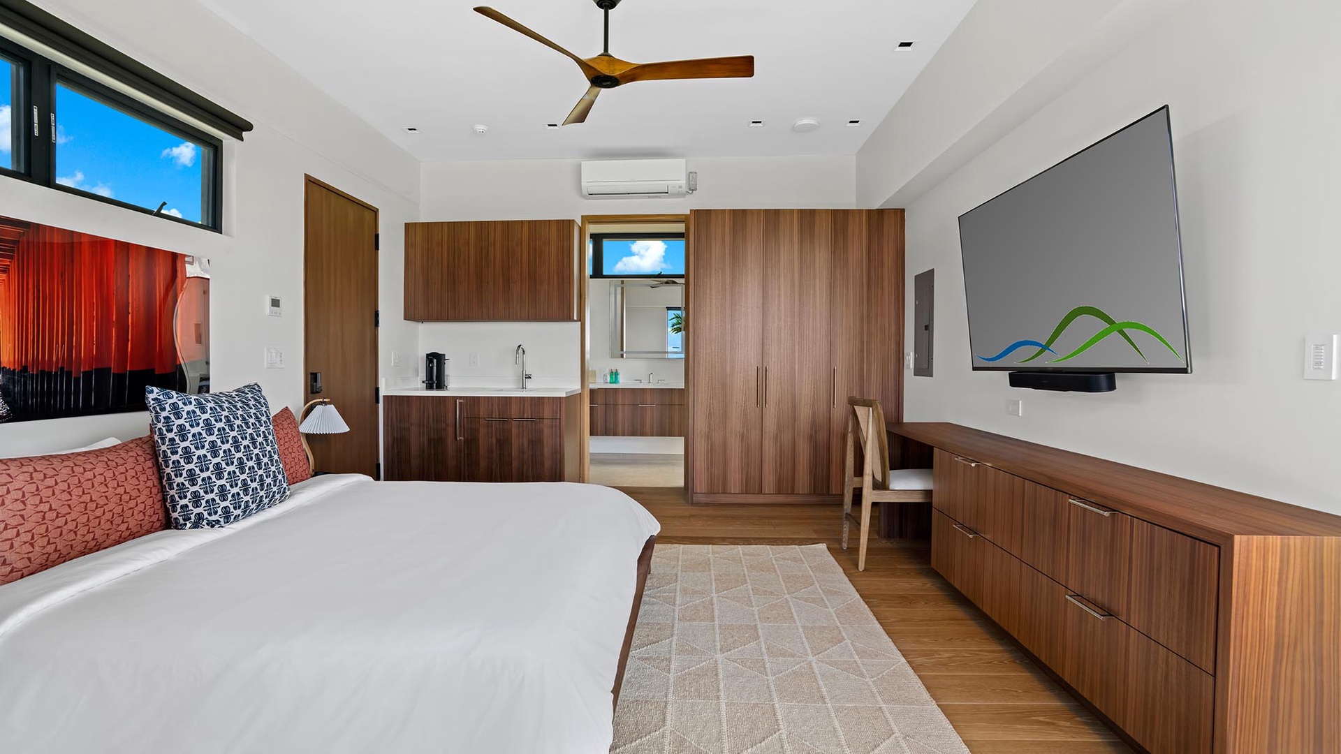 Your bright, modern bedroom features warm wood accents and an en-suite bathroom, with cool air-conditioning and ceiling fan to keep you comfortable.