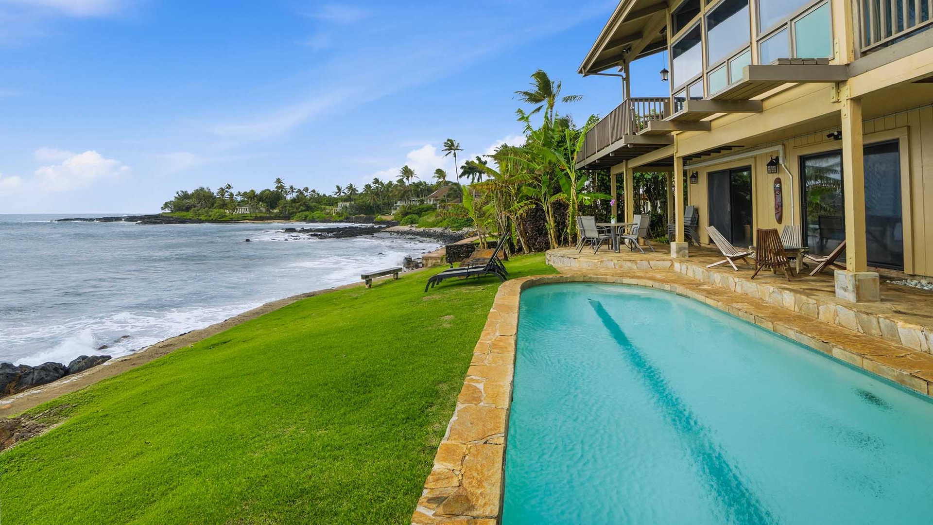 Oceanfront luxury with private pool steps from pristine waters. Palm trees sway as waves meet manicured lawns in this tropical paradise setting.