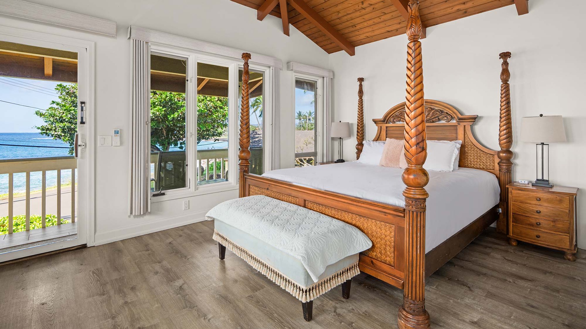 Your elegant four-poster bed awaits with ocean views through French doors leading to your private balcony.