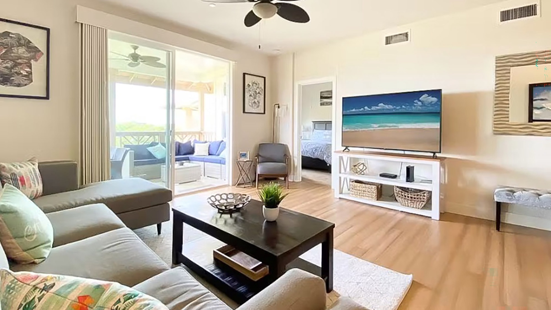 Settle into this bright, airy living space where coastal vibes meet comfort. Unwind on plush seating, enjoy your favorite shows, and step out to your private balcony—your home away from home awaits.