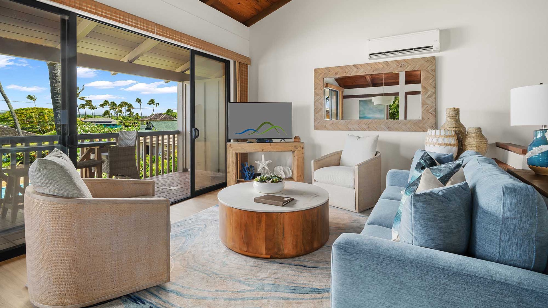 Relax in your spacious living room with coastal-inspired décor, high wooden ceilings, and air conditioning. Step onto your private balcony to enjoy lush tropical views and gentle island breezes.