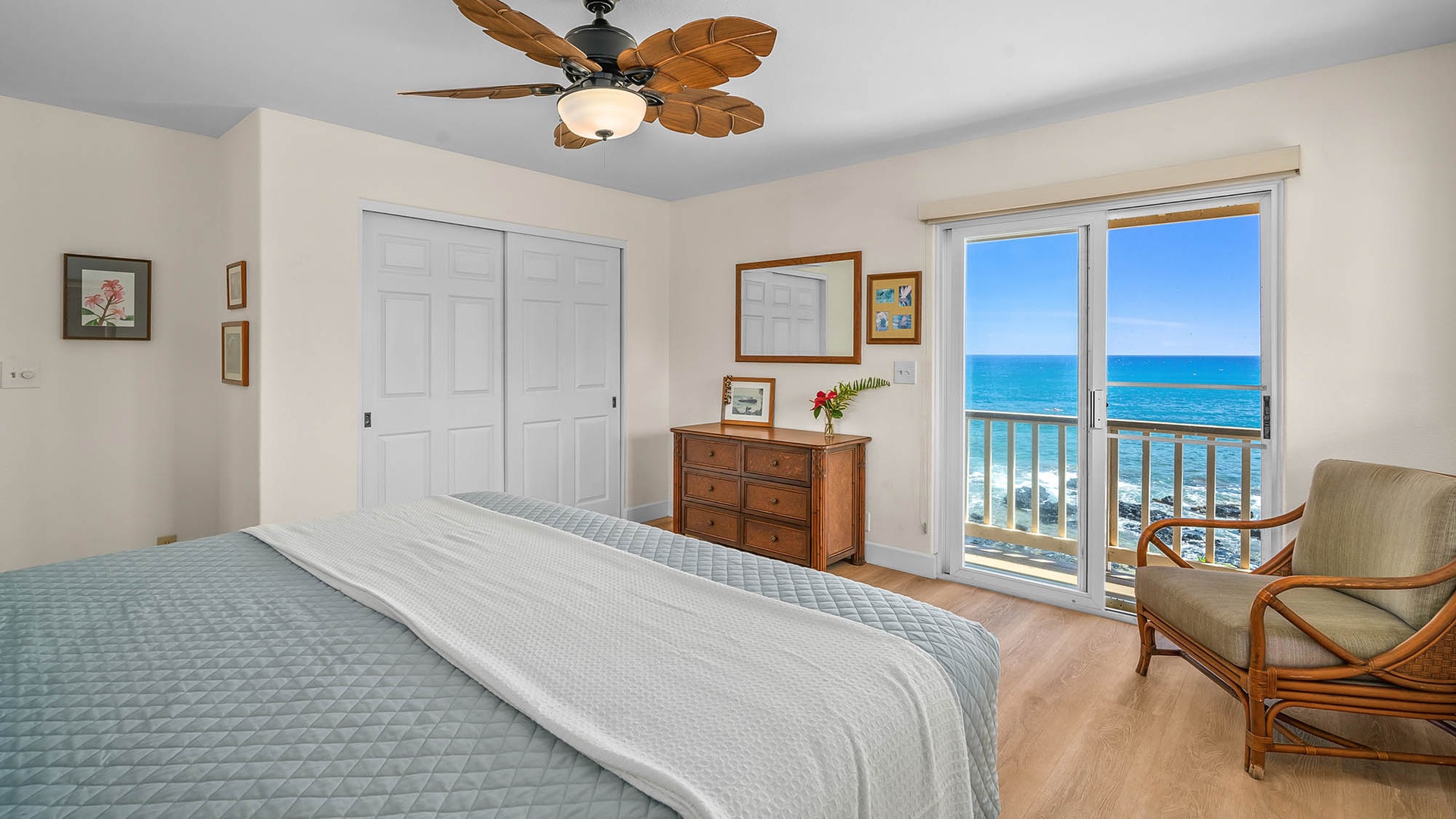 Wake up to breathtaking ocean views from your cozy bedroom, where tropical breezes and stunning sea horizons greet you each morning through sliding glass doors to your private balcony.