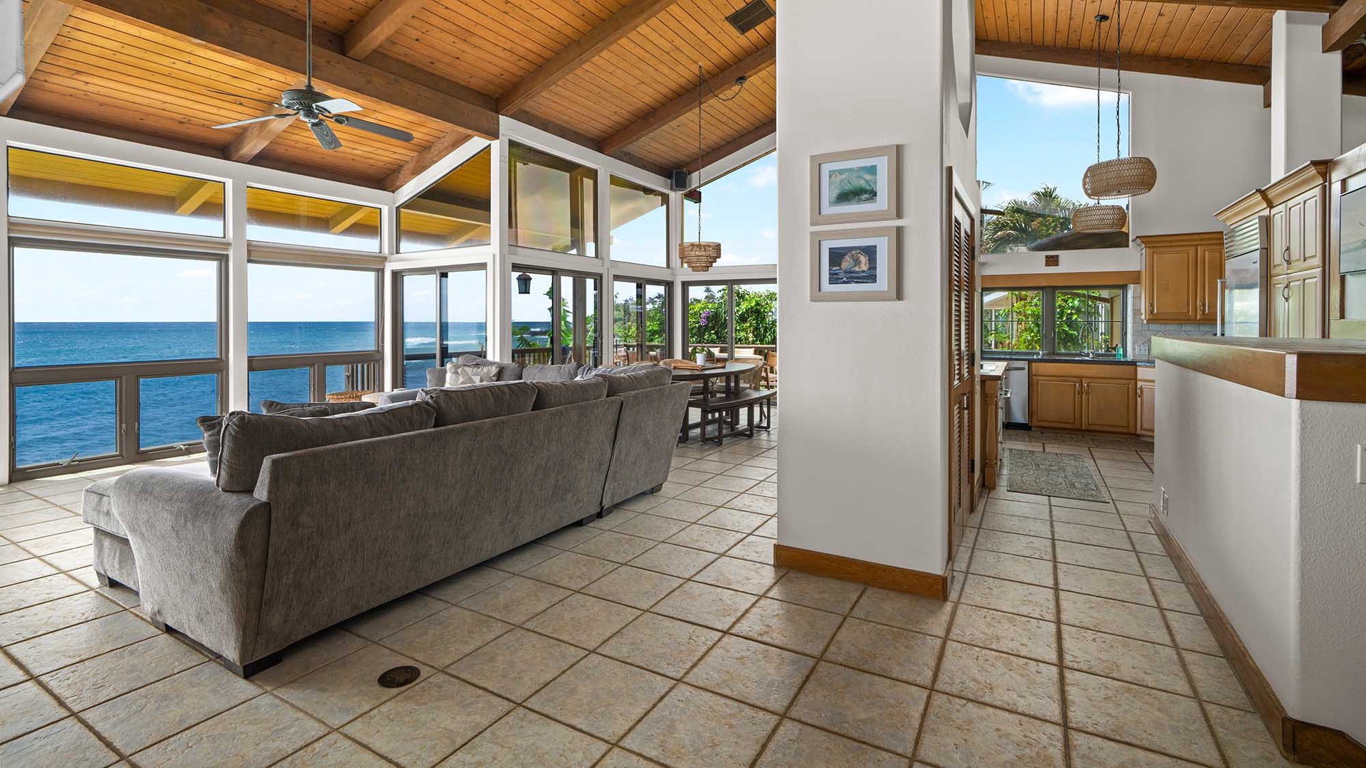 Relax in your open-plan living space with stunning ocean views through floor-to-ceiling windows and warm tropical breezes.