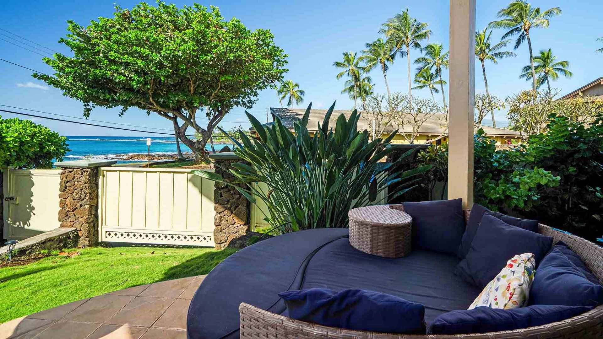 Your private patio offers the perfect spot to unwind with comfortable seating and stunning ocean views framed by swaying palms.