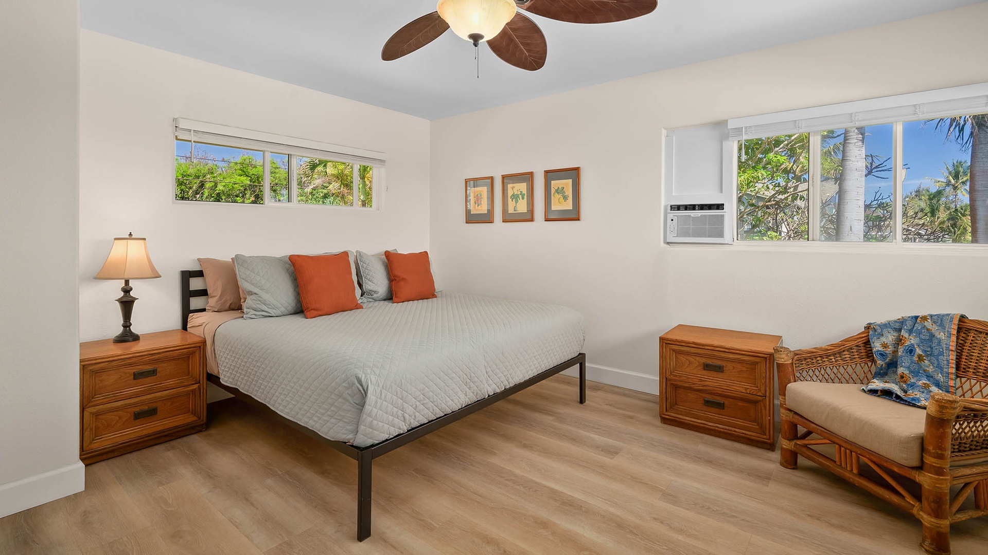 Wake up in your bright, breezy bedroom with tropical views framed by windows on both sides, inviting the lush greenery and island sunshine right to your bedside.