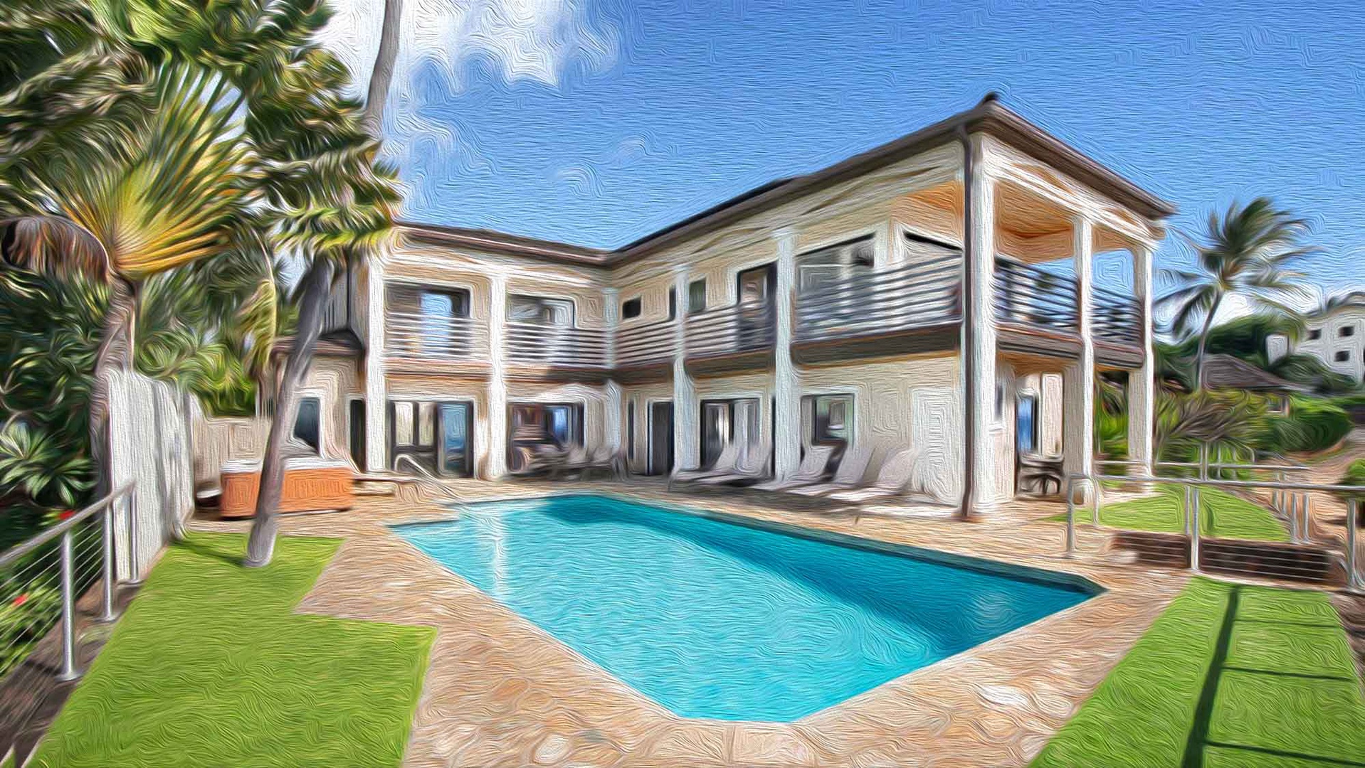 A spacious two-story tropical retreat surrounds a pristine private pool, framed by swaying palms and modern covered terraces under clear blue skies.