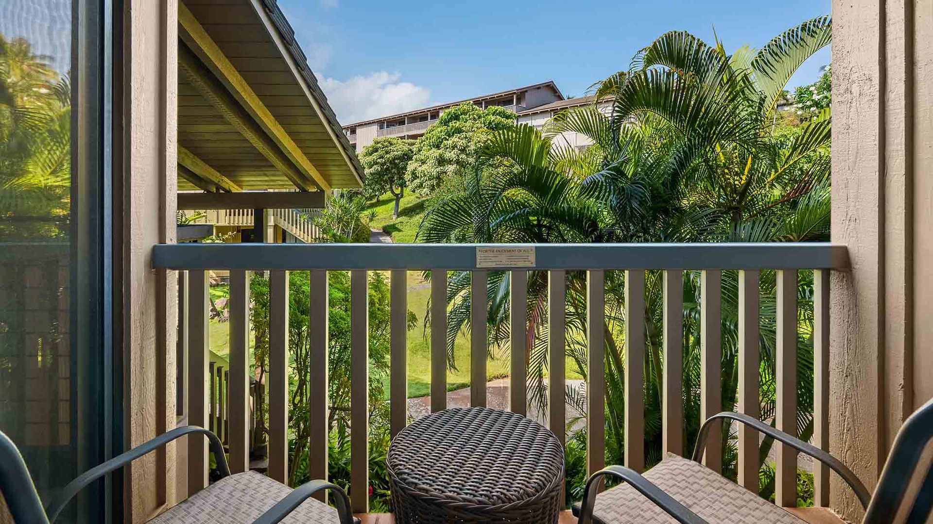 Sip your morning coffee on your private balcony surrounded by lush tropical palms and peaceful garden views.