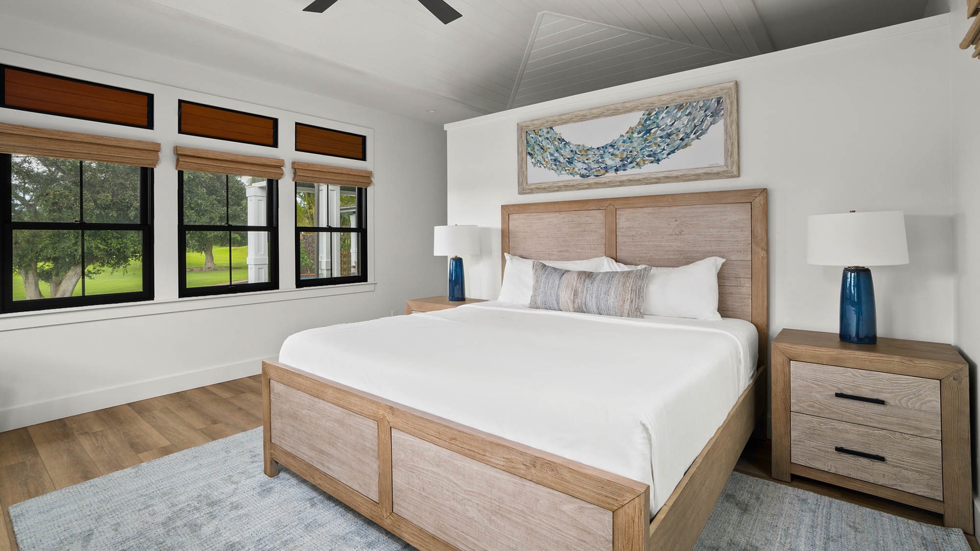 Rest easy in your serene bedroom with crisp linens and peaceful garden views through oversized windows.