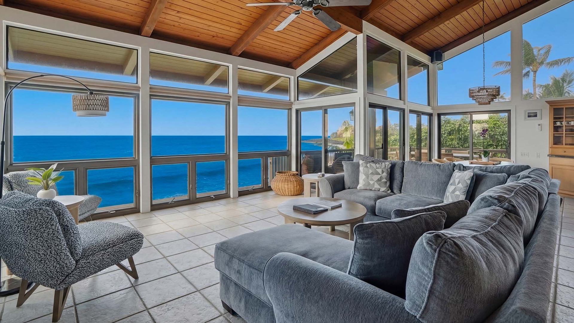 Sink into plush coastal comfort while endless ocean views stretch before you through floor-to-ceiling windows in this stunning oceanfront living space.
