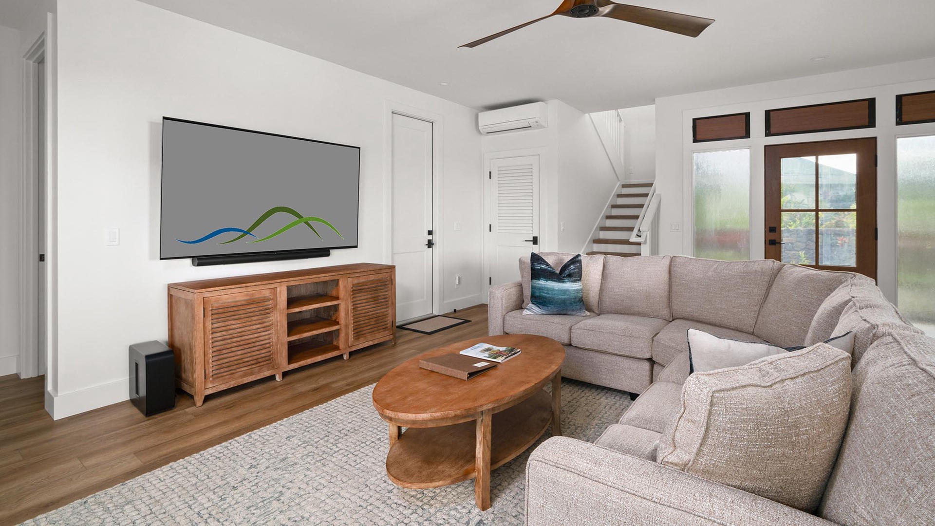 Sink into your spacious sectional sofa for movie nights on the large wall-mounted TV, while the ceiling fan keeps you cool.