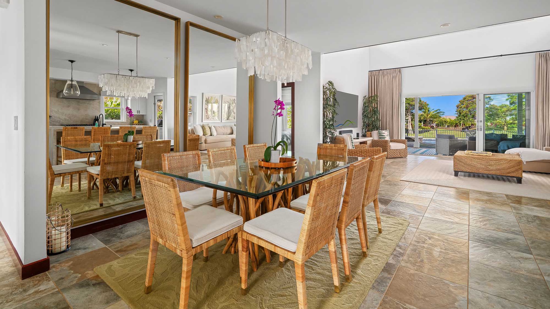 Picture yourself gathered around this elegant glass dining table, where sunlight streams through towering windows, illuminating your meals with warmth and tropical views beyond.