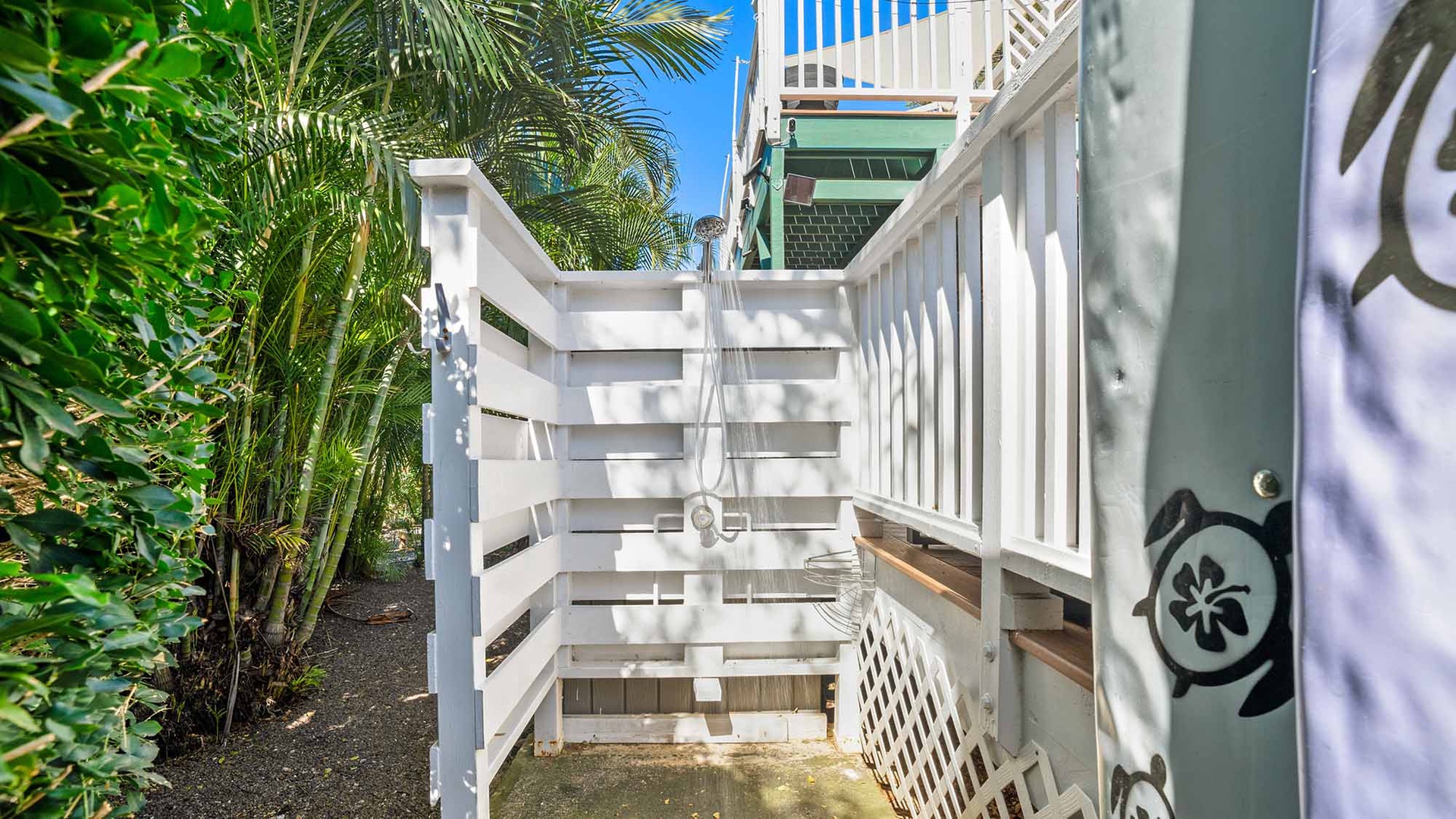 This private outdoor shower offers a refreshing rinse surrounded by tropical palms and sunshine after your beach day.
