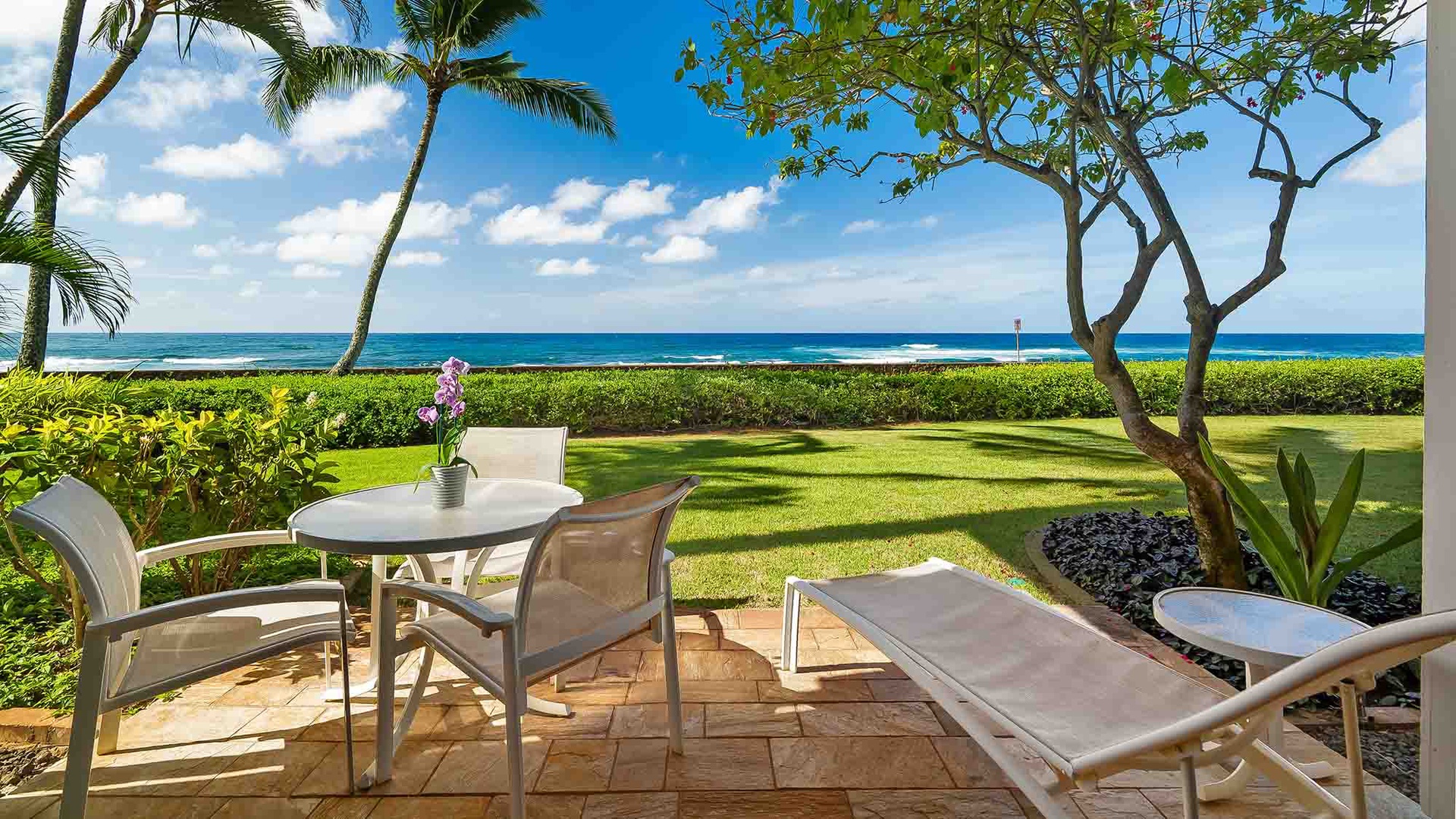 Step out onto your private patio and let the ocean breeze welcome you. With the endless blue sea stretching before you and soft grass beneath swaying palms, this is your front-row seat to paradise.