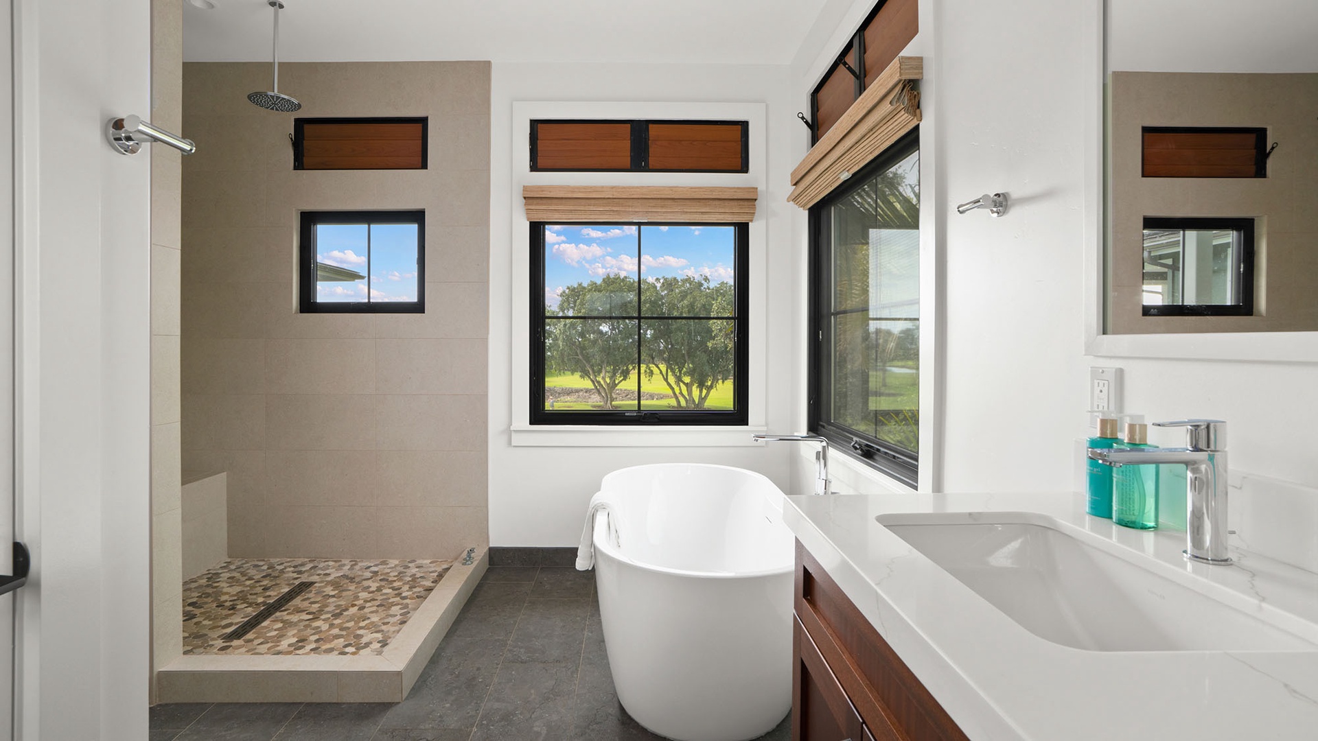 Unwind in your luxurious bathroom featuring a soaking tub with peaceful countryside views and a spacious walk-in shower.