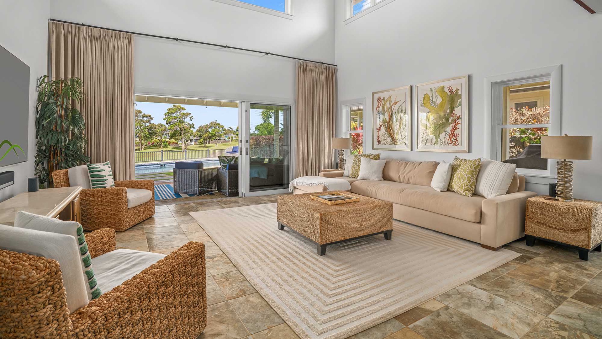 Settle into this bright, spacious living room where soaring ceilings and soft natural light create a serene escape. Slide open the glass doors to your private pool and patio, perfect for morning coffee or evening relaxation.