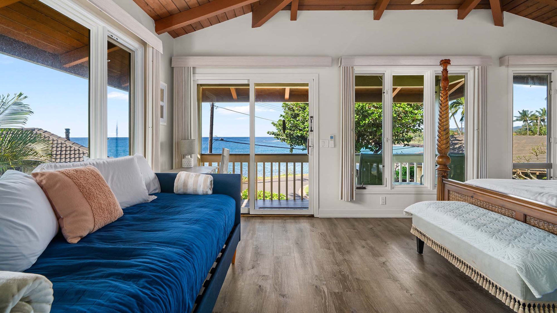 Wake up to stunning ocean views from your comfortable bedroom with exposed beams and private balcony access.