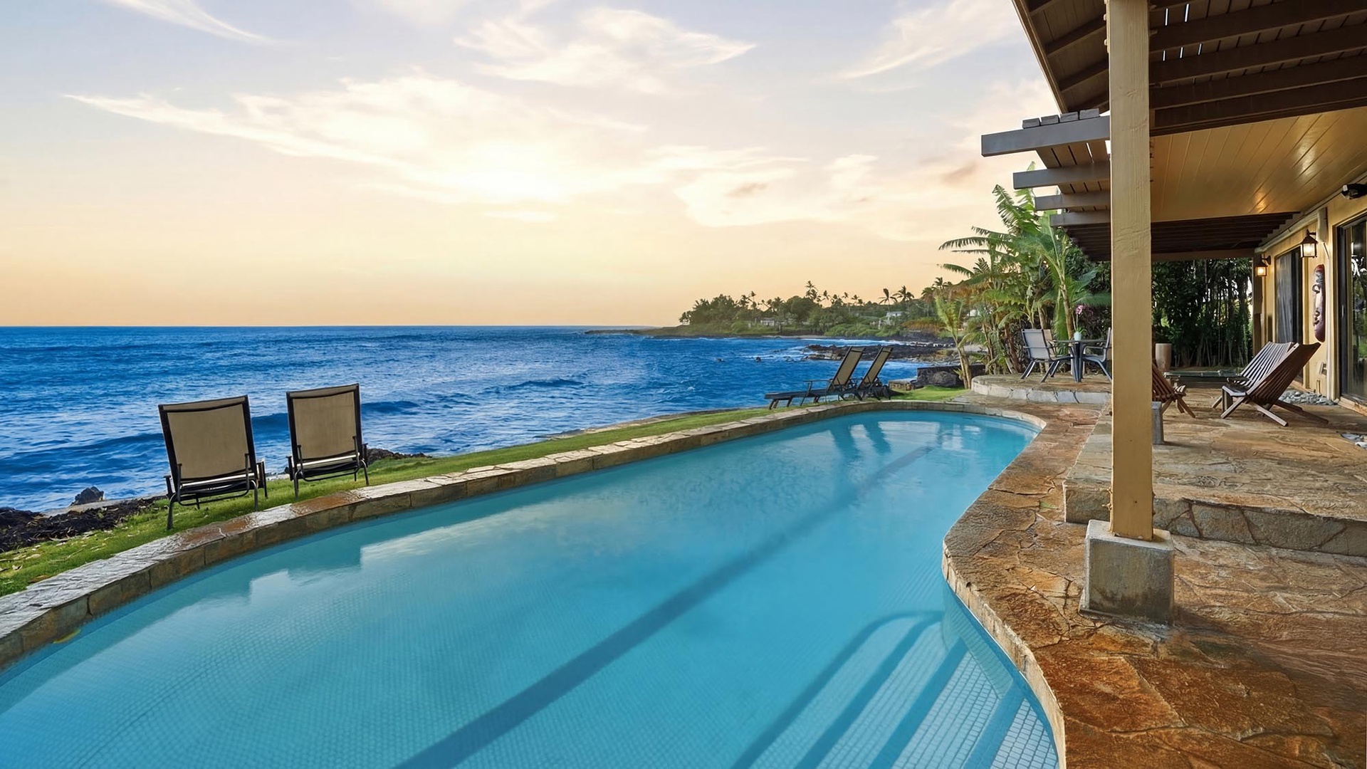 Your private oceanfront pool awaits, where turquoise waters mirror the endless Pacific horizon in absolute luxury.