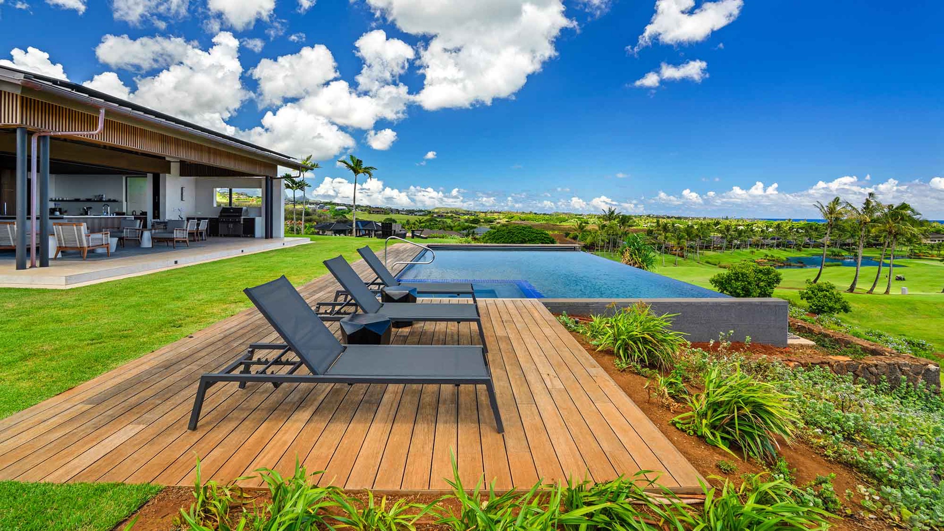 Your private infinity pool overlooks lush fairways and tropical greenery, with loungers perfectly positioned for soaking up island sunshine and endless blue skies.