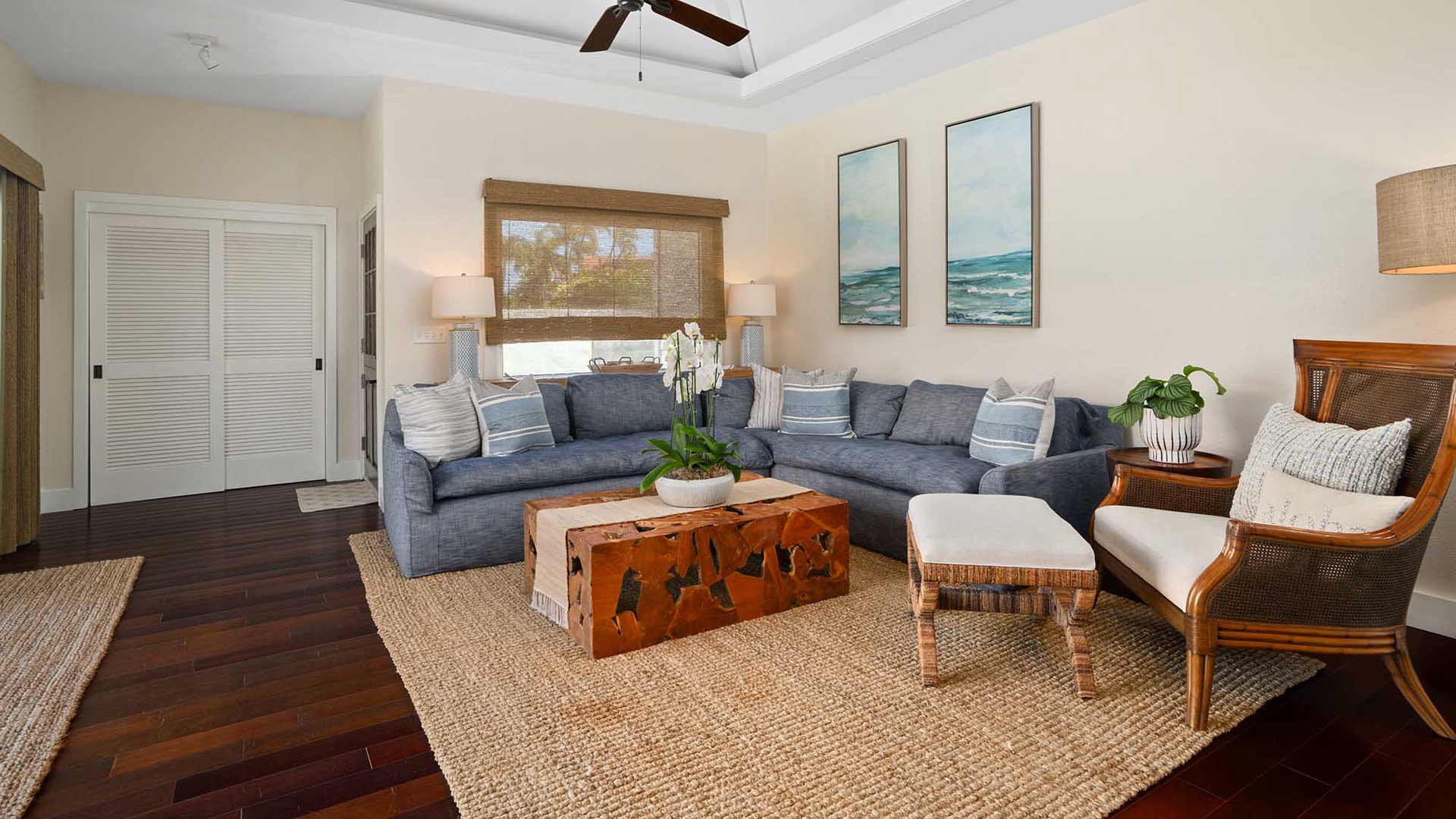 Sink into plush sofas in your bright, coastal-inspired living room, where natural textures and soothing ocean art create the perfect backdrop for your vacation moments together.