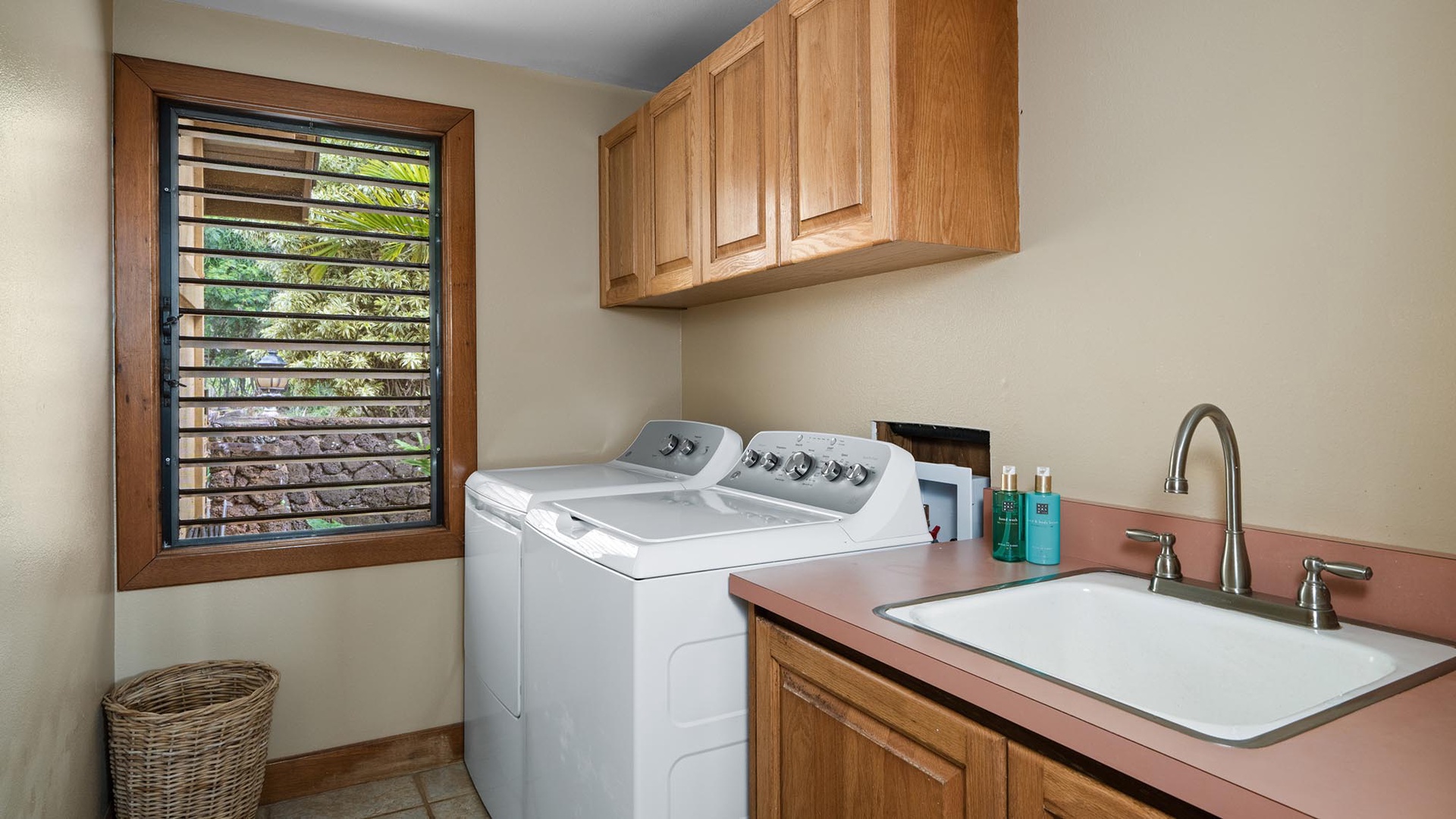 Your private laundry room makes extended stays effortless with full-size appliances, a deep sink, and natural light streaming through louvered windows.