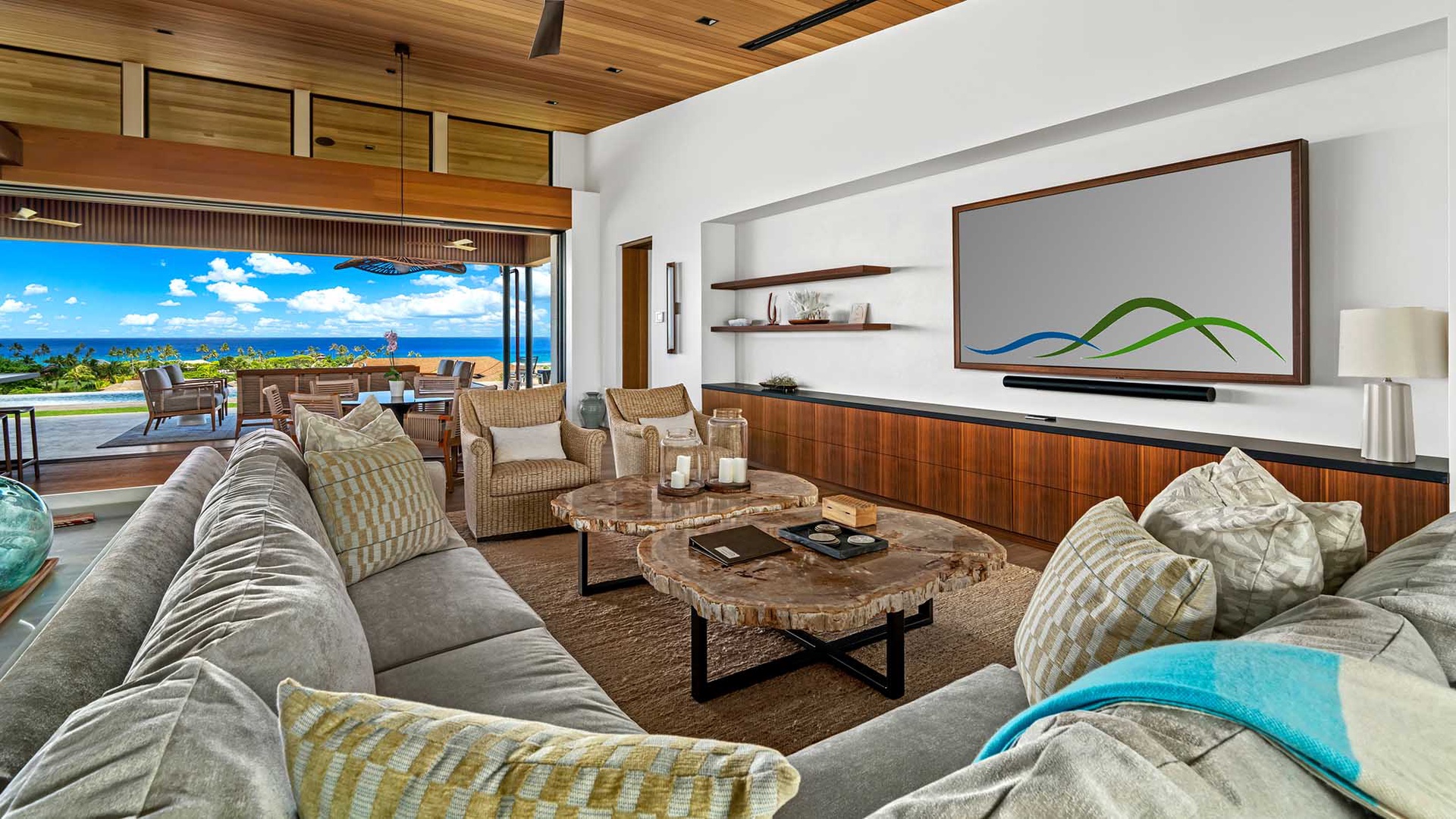Unwind in your spacious living area where plush seating and natural wood accents frame breathtaking ocean views. Feel the warm tropical breeze as your private oasis seamlessly connects indoor comfort with the beauty outside.