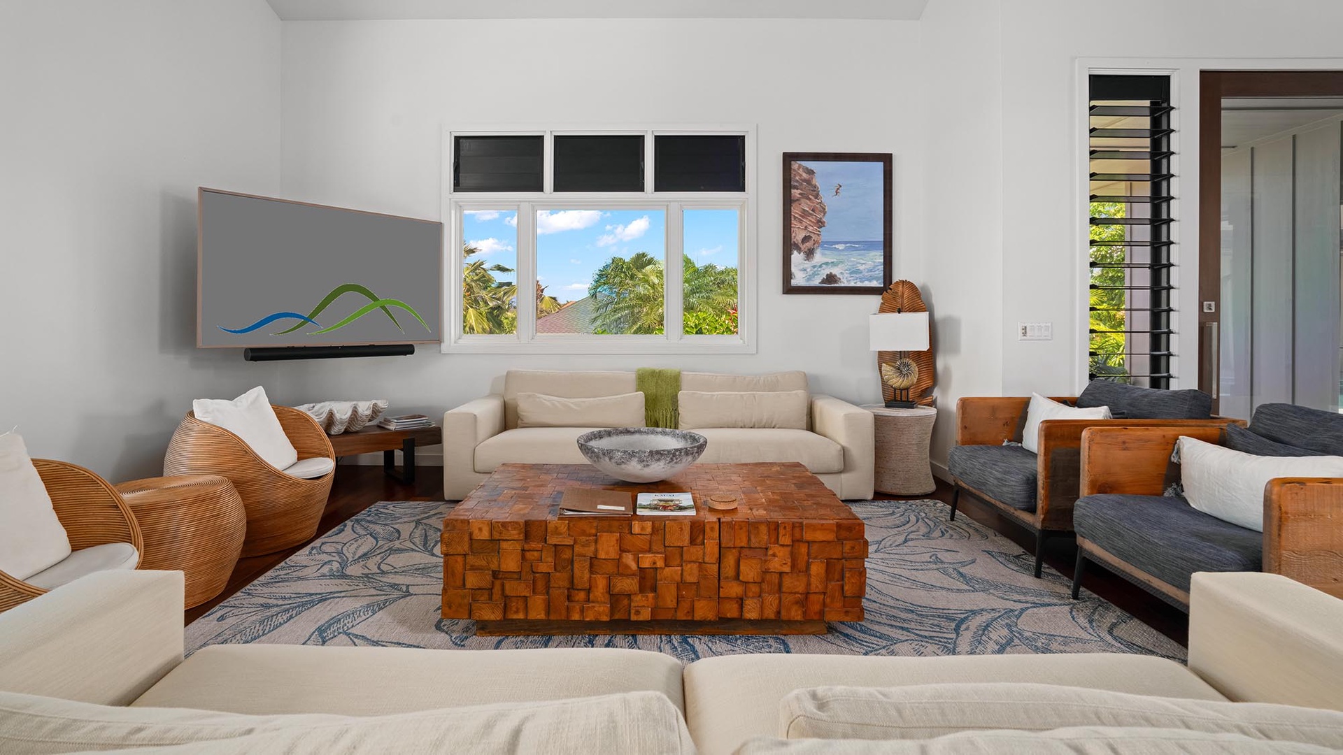 Sink into plush seating and admire lush tropical views through expansive windows. Your perfect retreat blends natural warmth with modern comfort for serene island living.