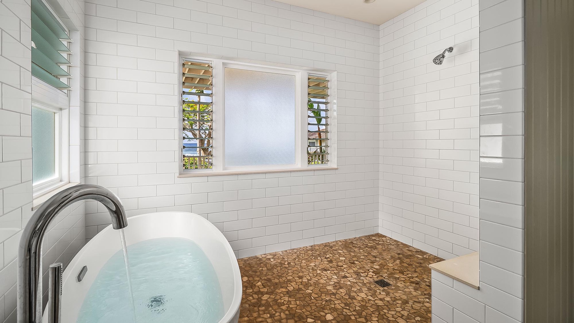 Soak in the tub or rinse off in the walk-in shower, all while enjoying your private glimpses of the sea through plantation-style shutters.