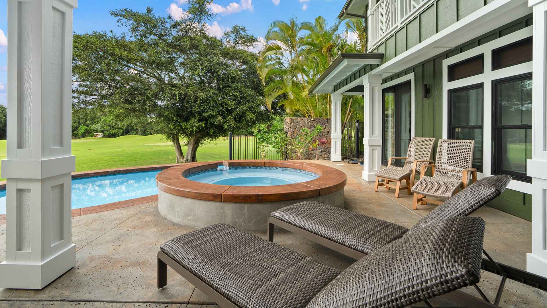 Relax on your private patio with pool and hot tub, surrounded by lush tropical gardens and open green spaces.