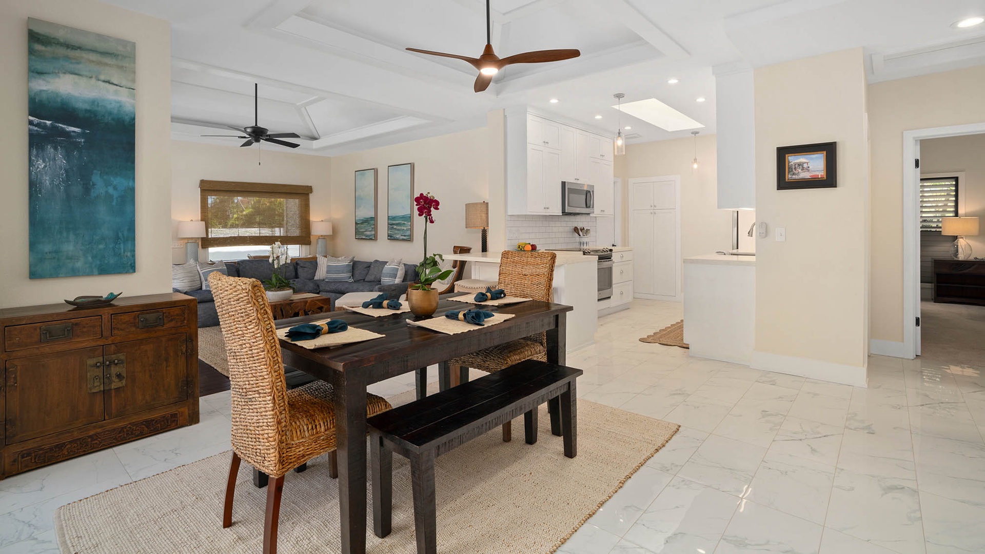 Relax in your airy open-concept living and dining space, where coastal artwork and woven textures create a calming, beach-inspired retreat you'll love coming home to.