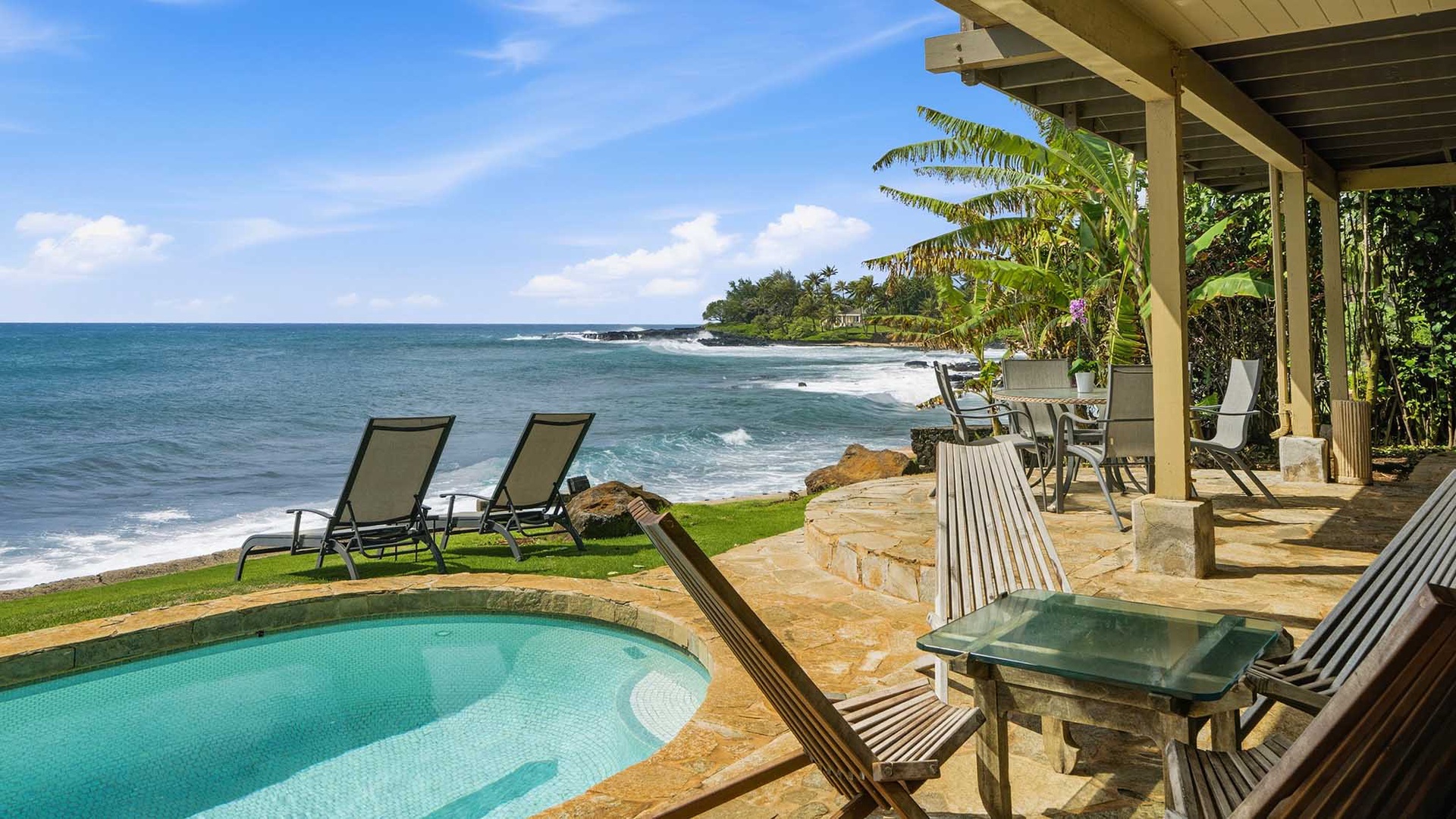 Relax poolside while waves crash just steps away—your private oceanfront paradise with tropical breezes and endless sea views.