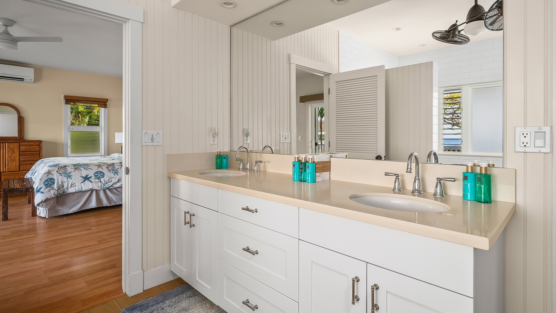 Freshen up at the double vanity, thoughtfully stocked with premium amenities and bathed in natural light from the window. Your private bedroom awaits just steps away.