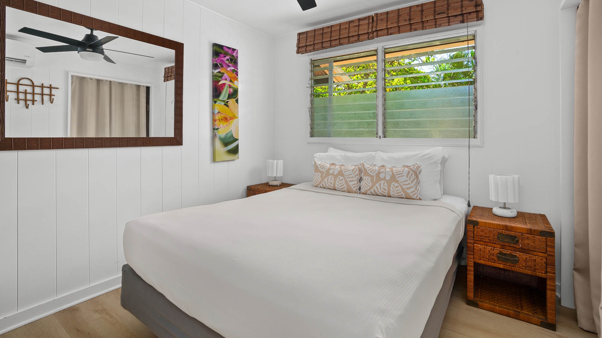 Sink into crisp white linens and wake up to natural light streaming through louvered windows. Your peaceful retreat features tropical accents and airy island charm.