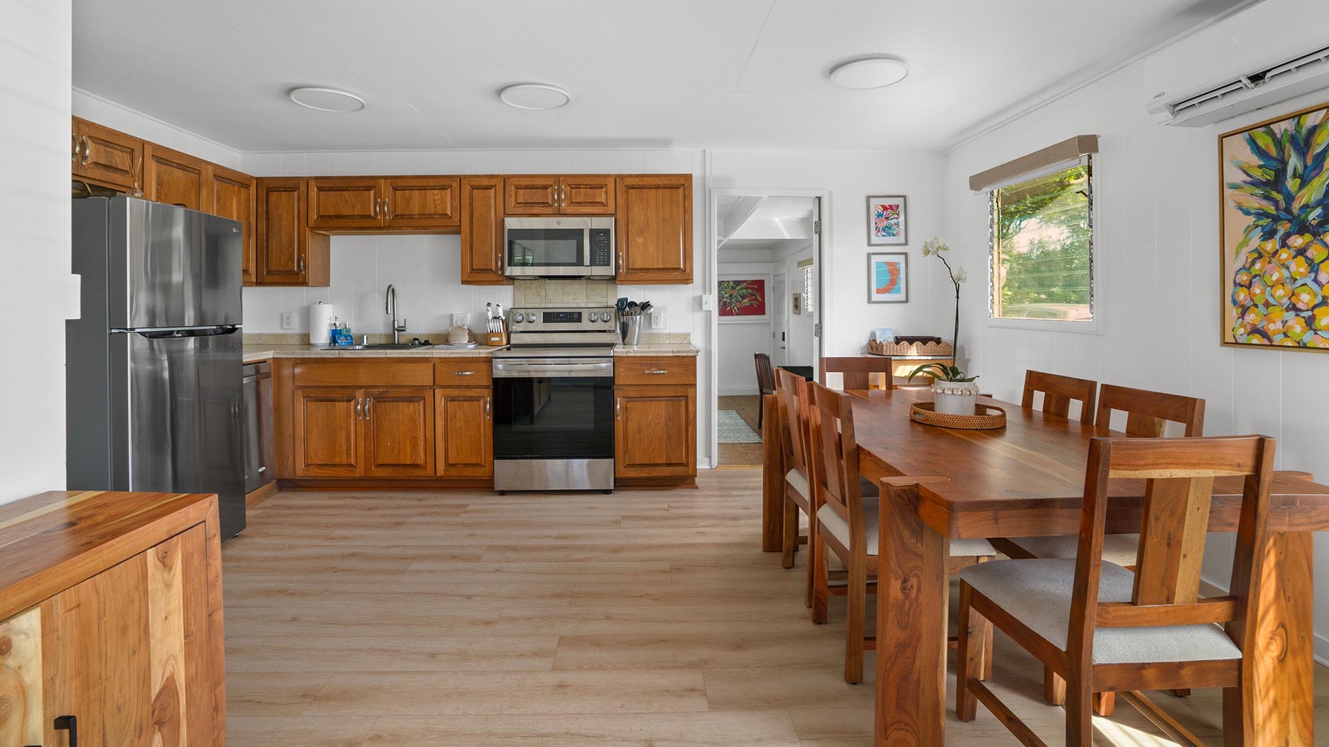 Picture yourself preparing meals in this welcoming kitchen, complete with modern appliances and rich wood cabinetry. Gather around the dining table for home-cooked dinners, bathed in natural light streaming through sunny windows.
