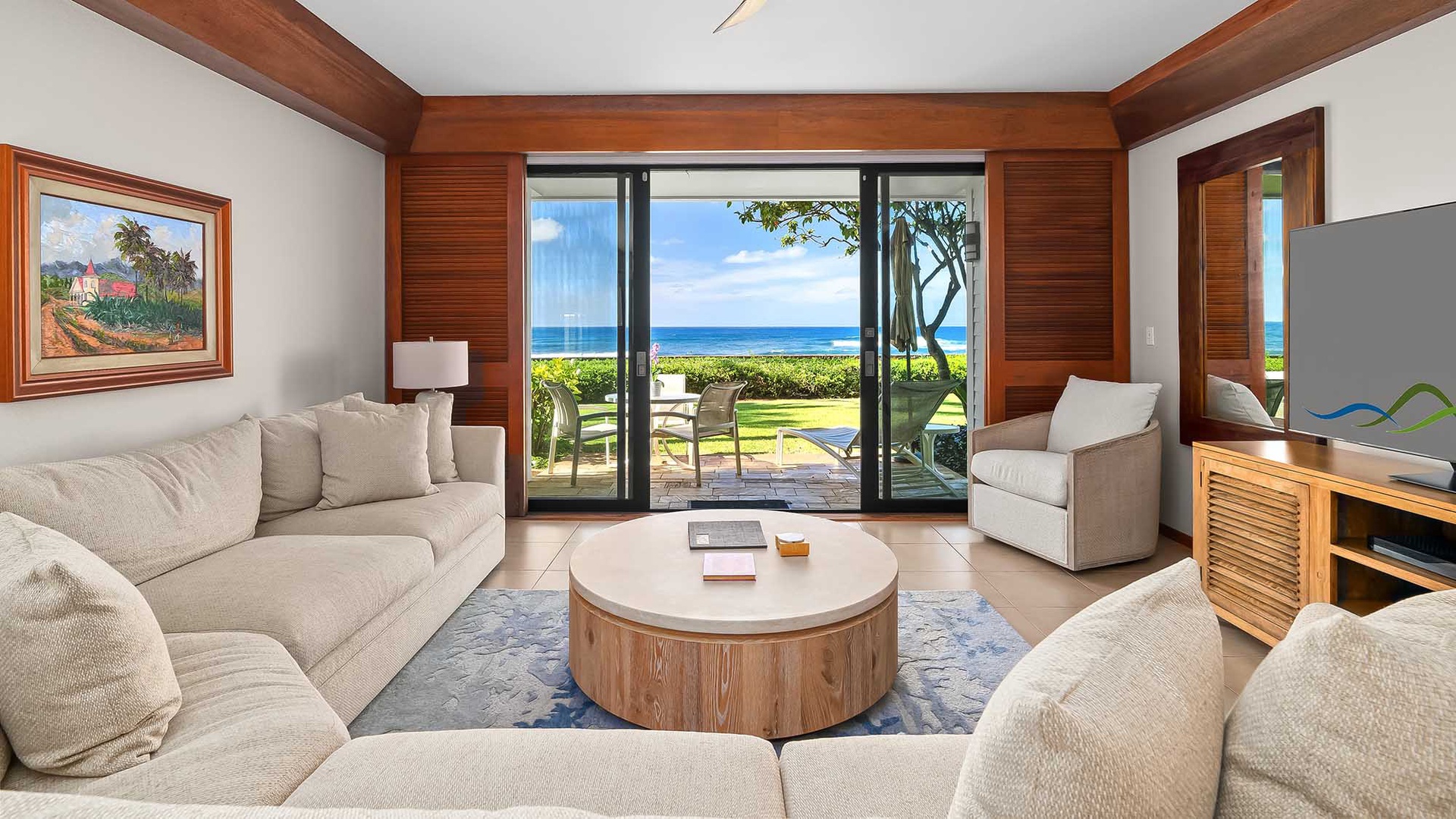 Step into your island retreat where plush seating invites you to unwind as ocean breezes drift through the open doors and the soothing sound of waves beckons you outside.
