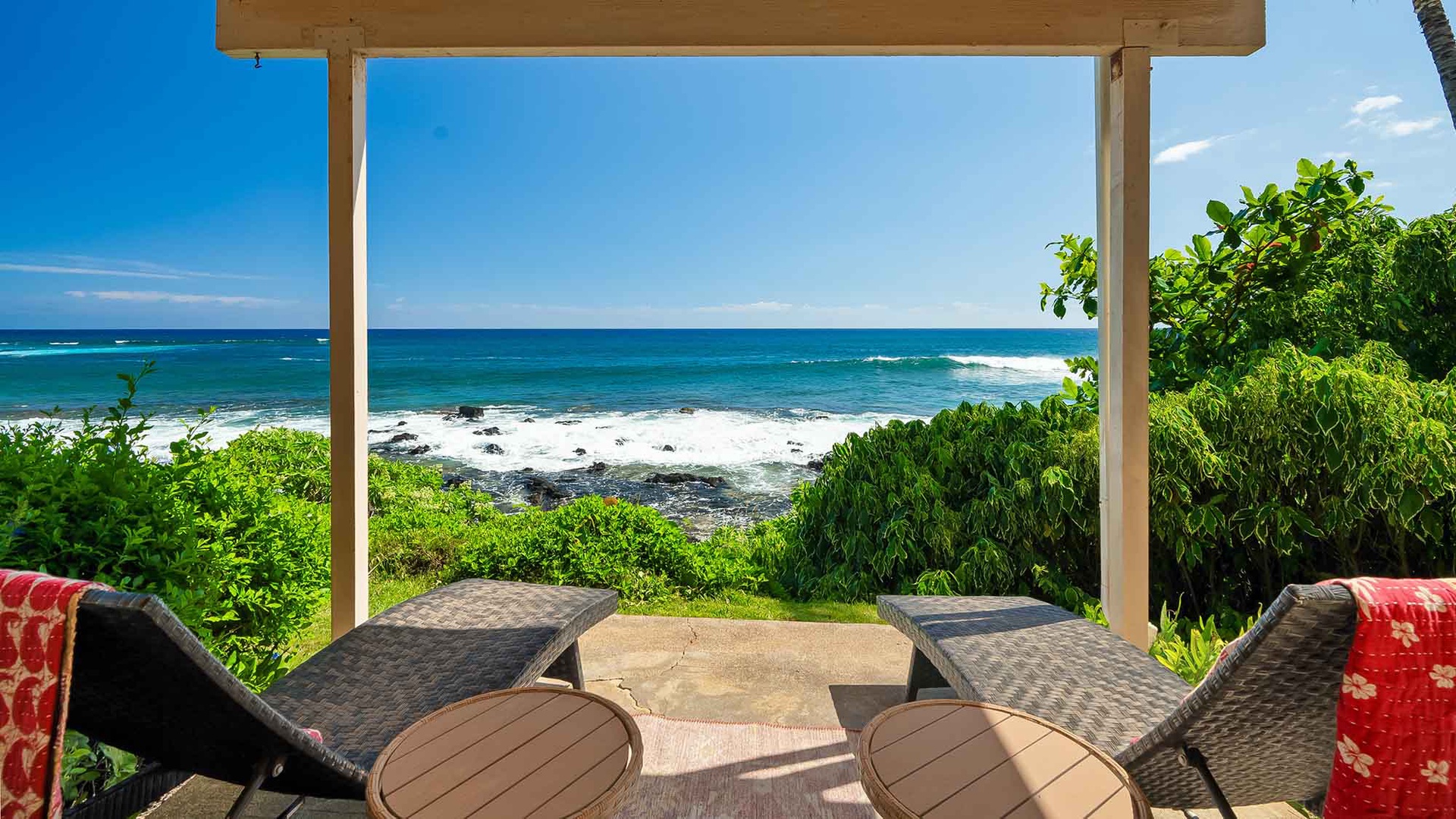 Breathe in the salt air and feel the ocean breeze from your private beachfront terrace, where tropical waves and lush greenery create your personal paradise.
